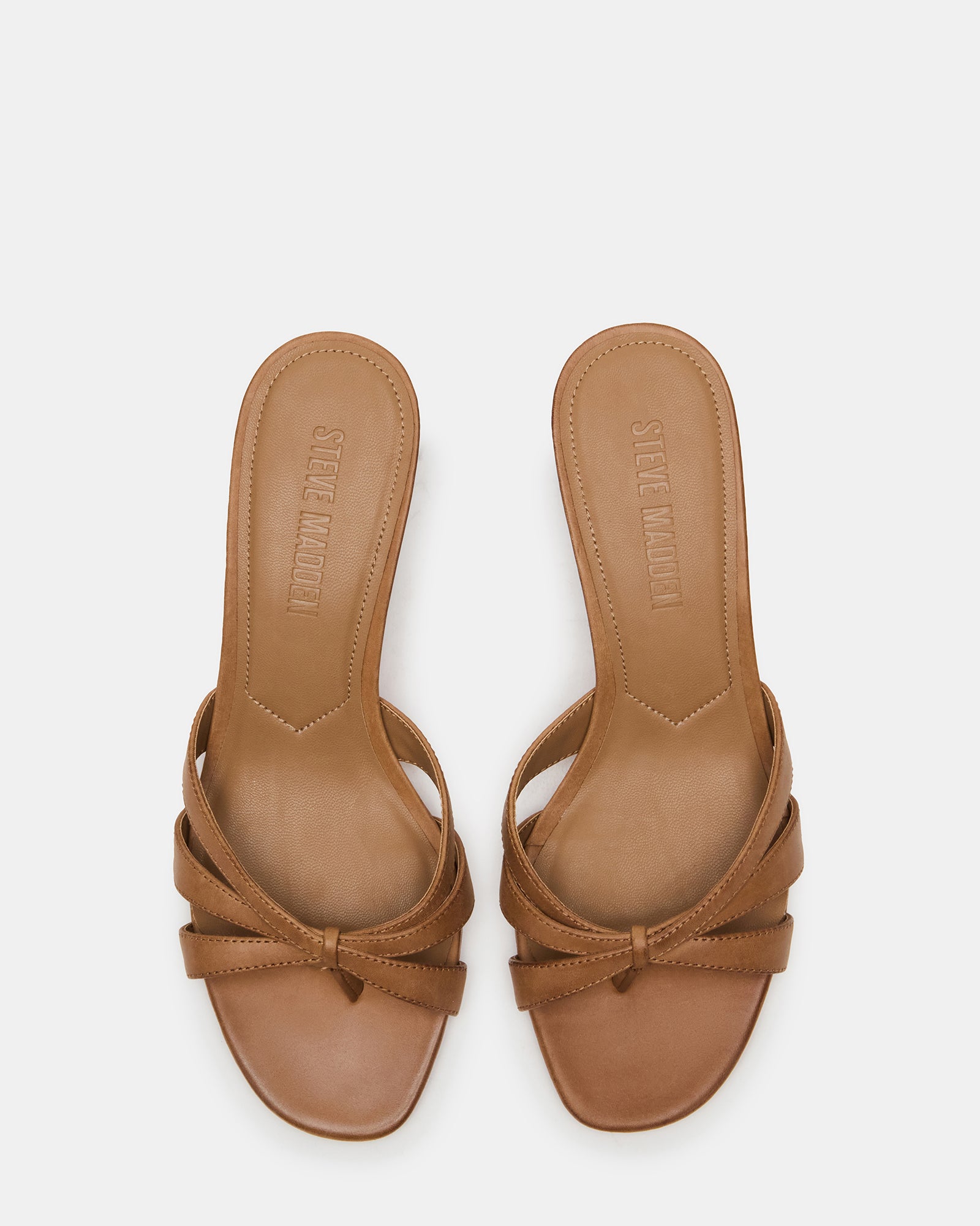 Cary camel leather mules worn with a sundress, showcasing the open toe design.