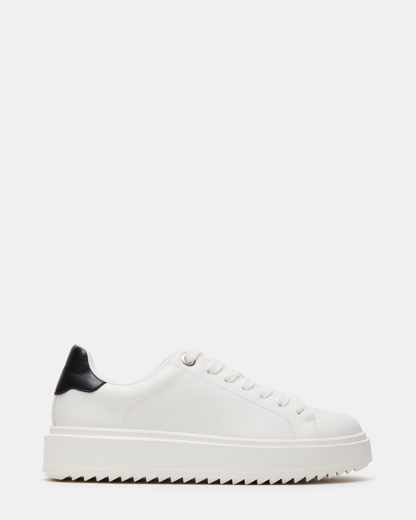 Side view of white sneakers with black accents on wooden bench
