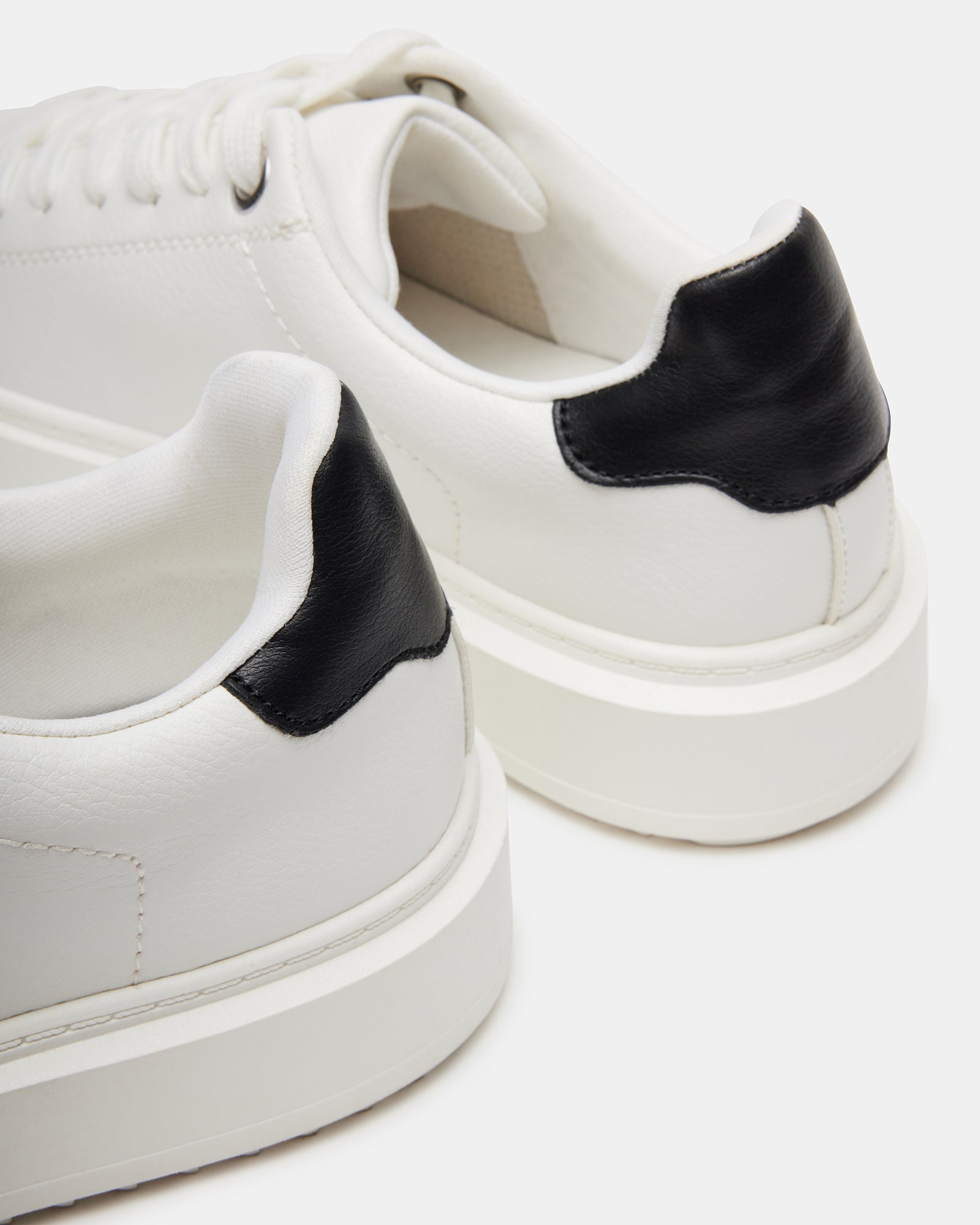 Front angle showing classic kick sneakers styling with jeans