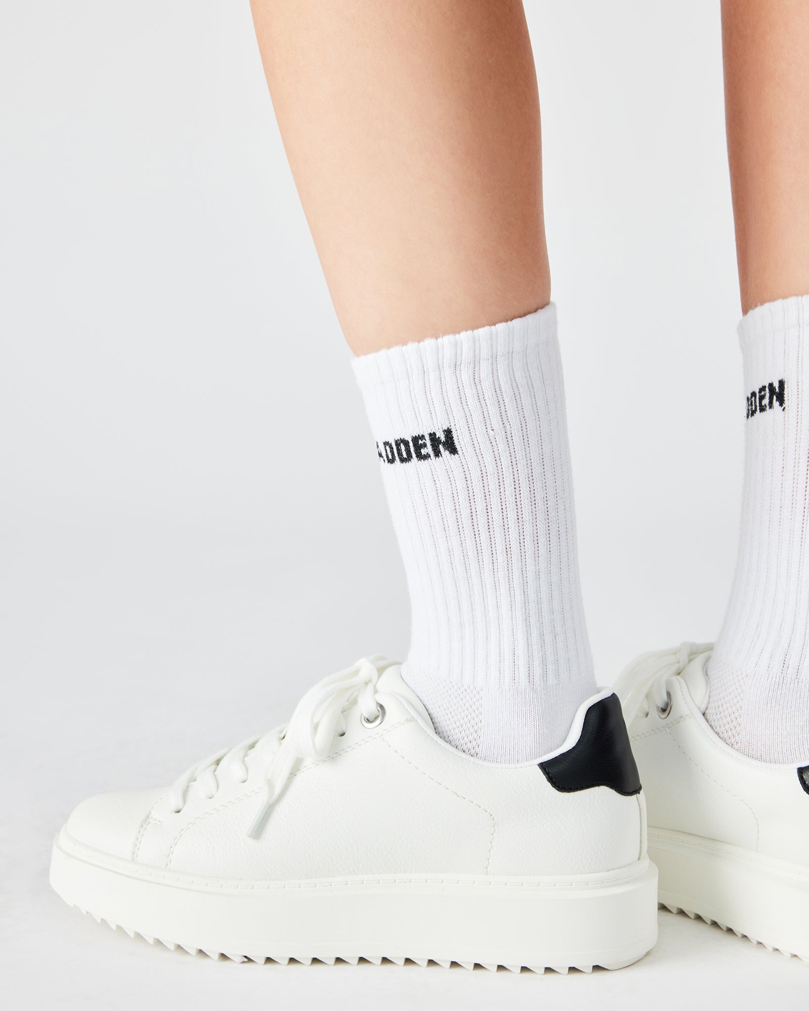 Front angle showing classic kick sneakers styling with jeans