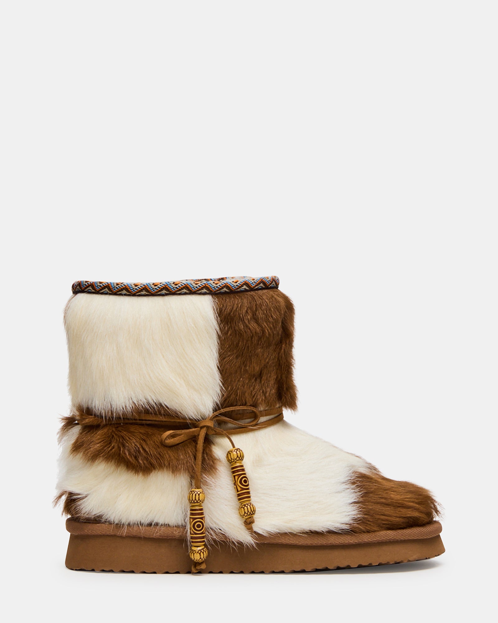 Side profile of women's ankle boots with faux fur cow print design