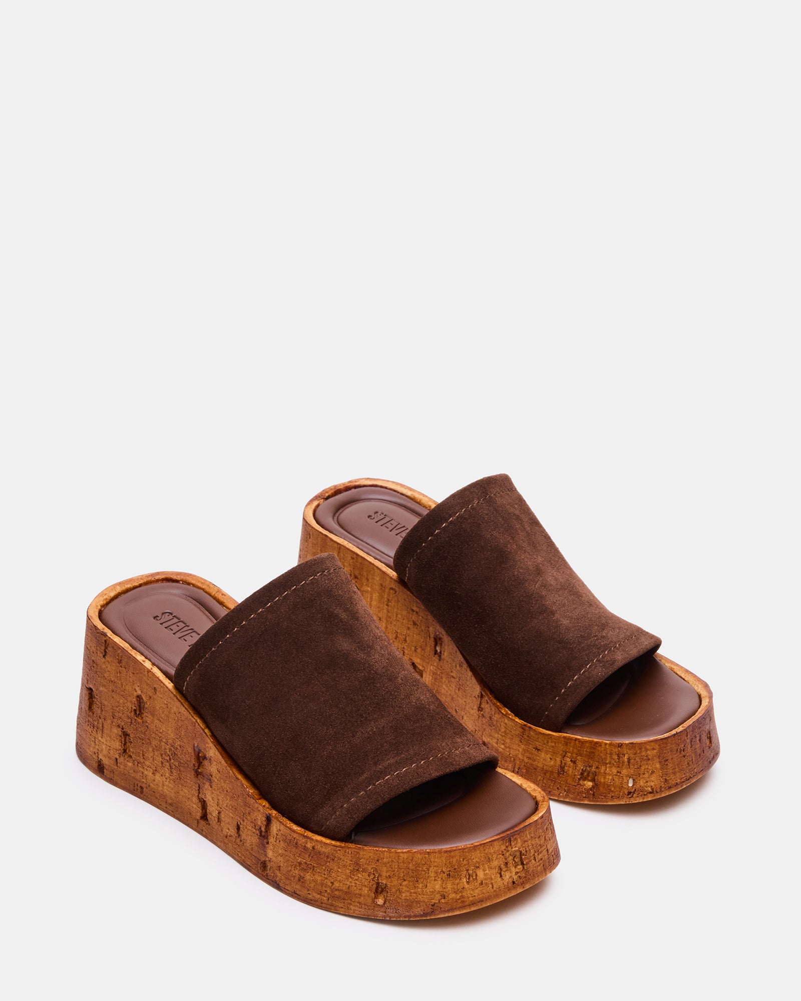 Close-up of the heel and platform of the brown suede wedge sandals