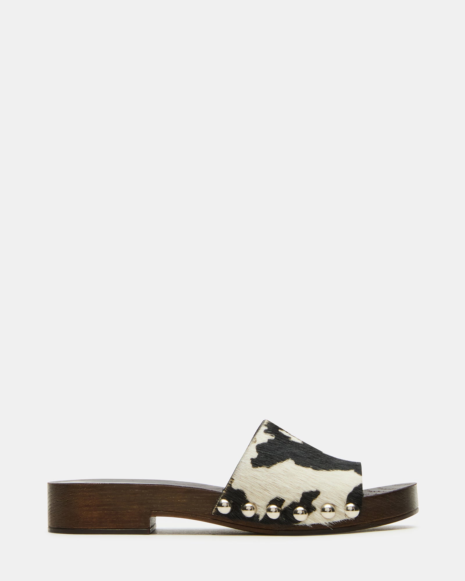 Close-up of black studded slide sandals showcasing leather details