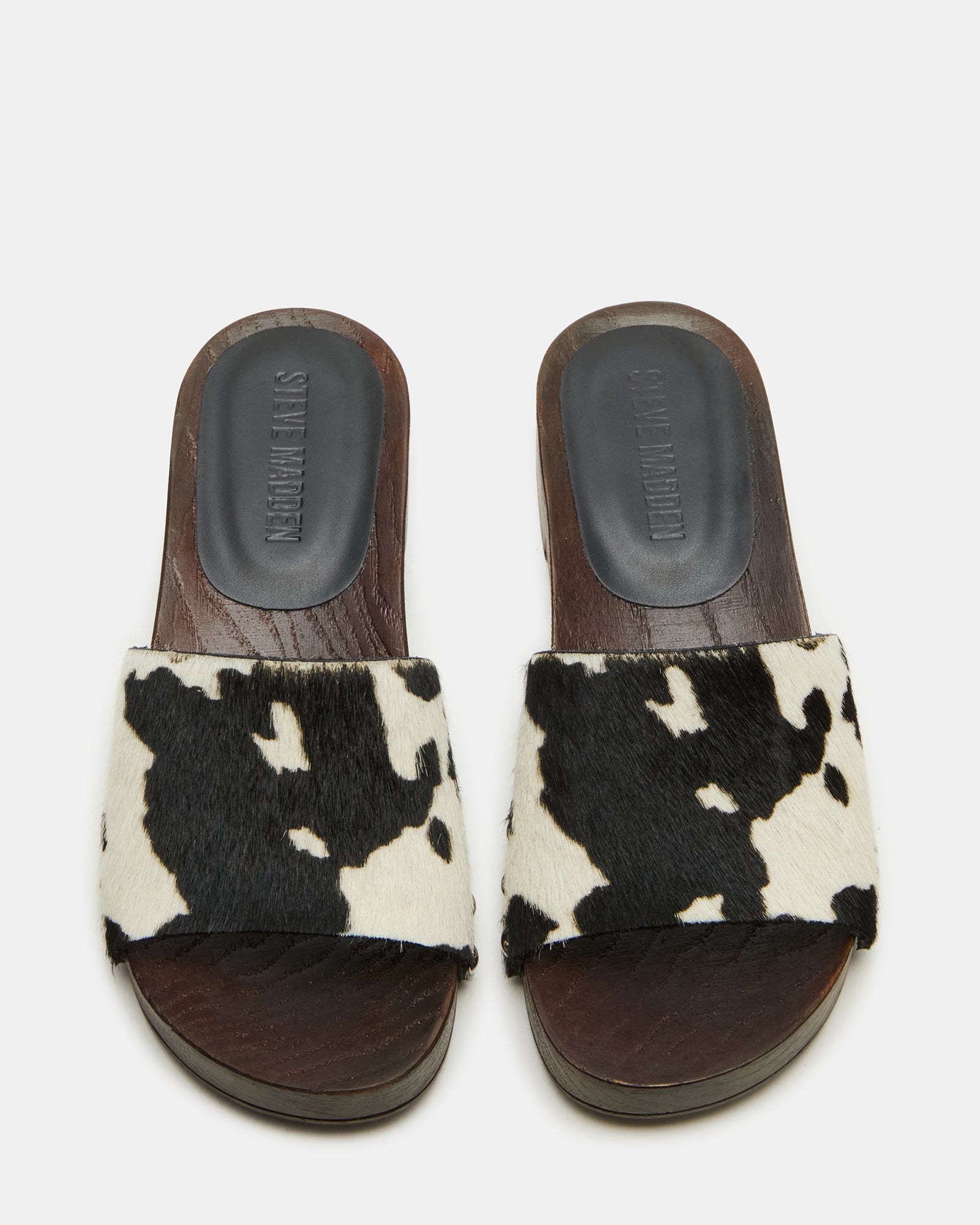 Close-up of black studded slide sandals showcasing leather details