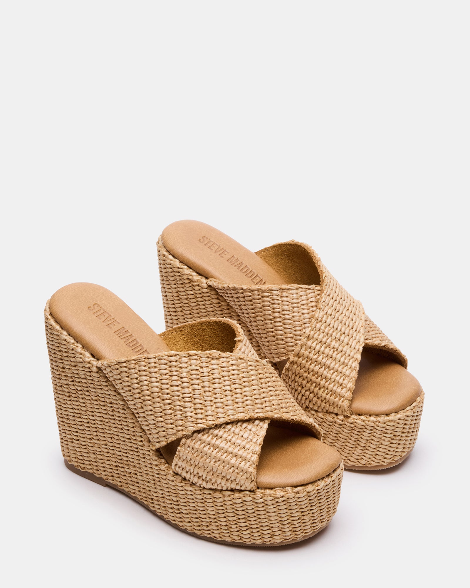 Close-up of black platform sandals featuring square-toe and mule construction