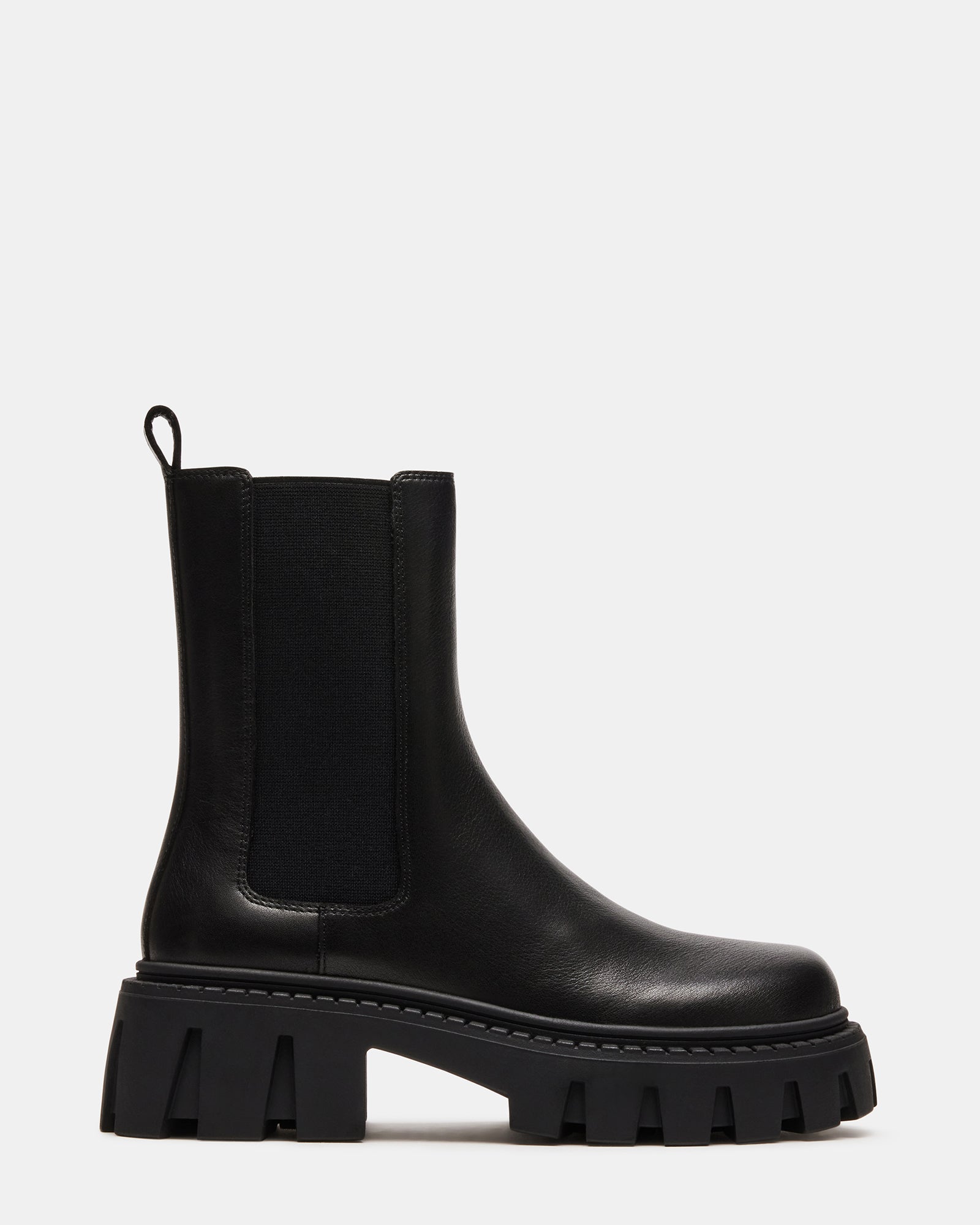 Side view of black leather Chelsea boots showcasing the elastic gore and zipper closure.