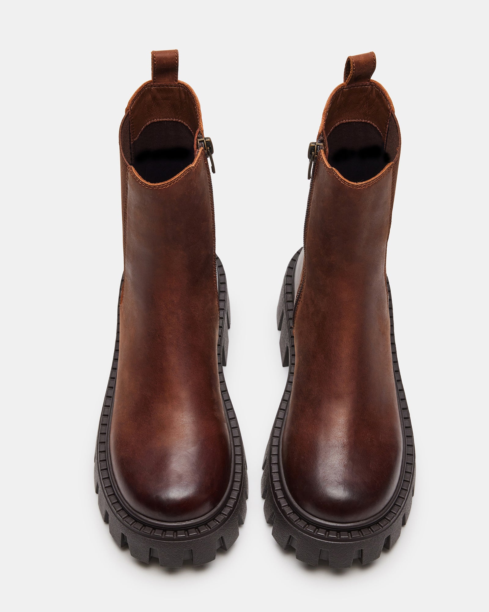Distressed brown leather Chelsea boots with rugged sole, angled view