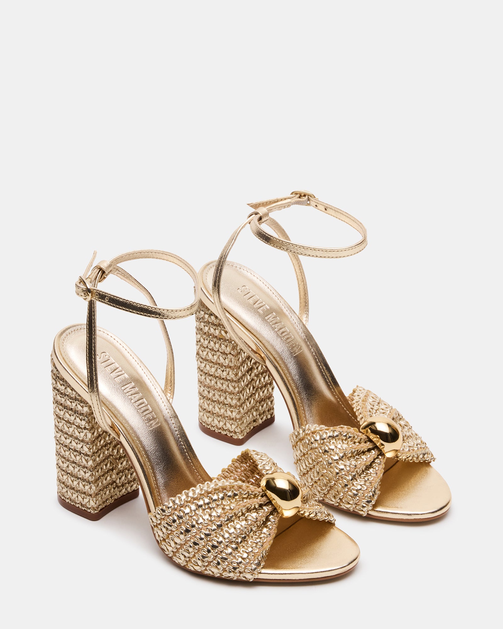 Top-down angle showing secure ankle strap and raffia heel texture on womens platform sandals