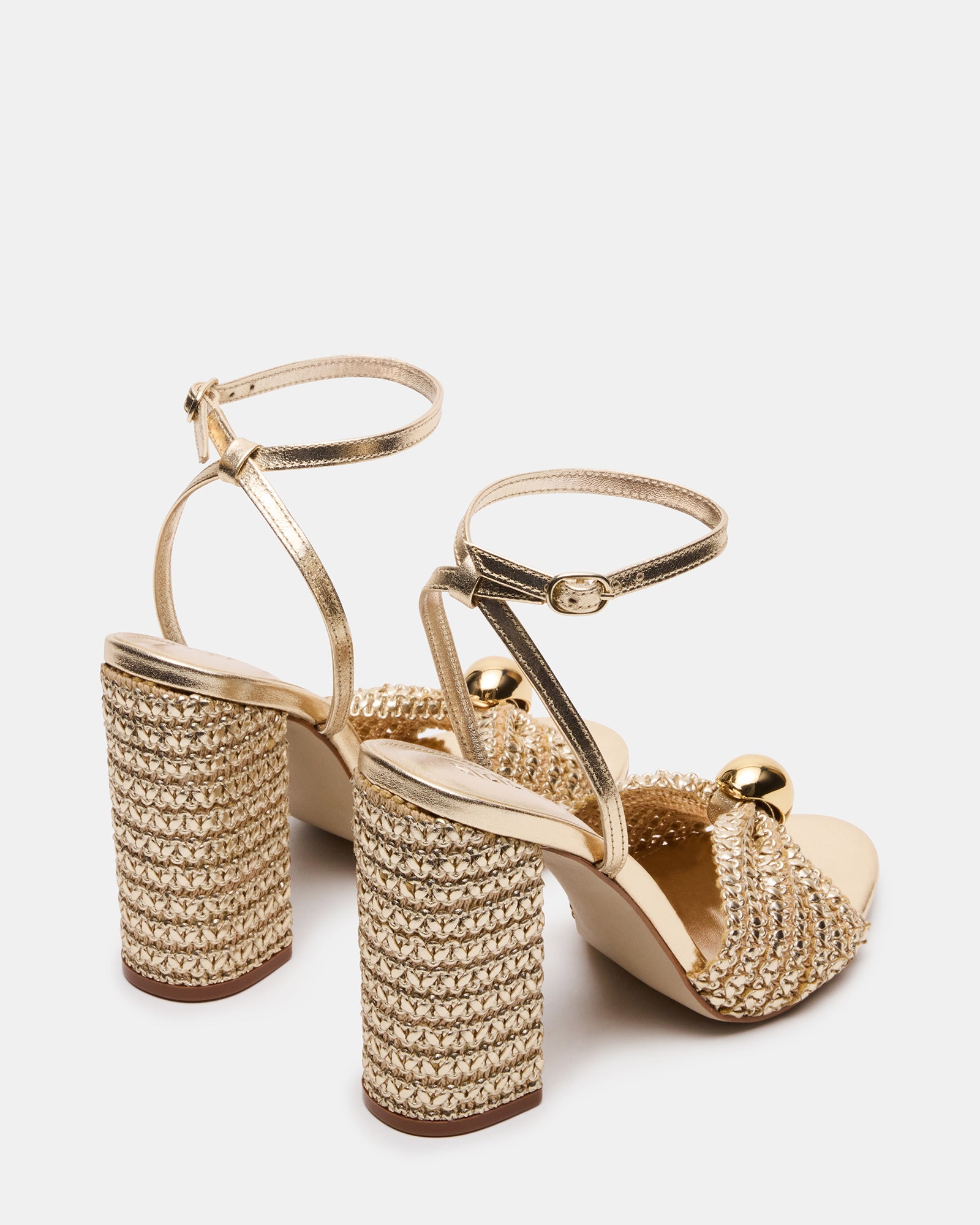 Top-down angle showing secure ankle strap and raffia heel texture on womens platform sandals