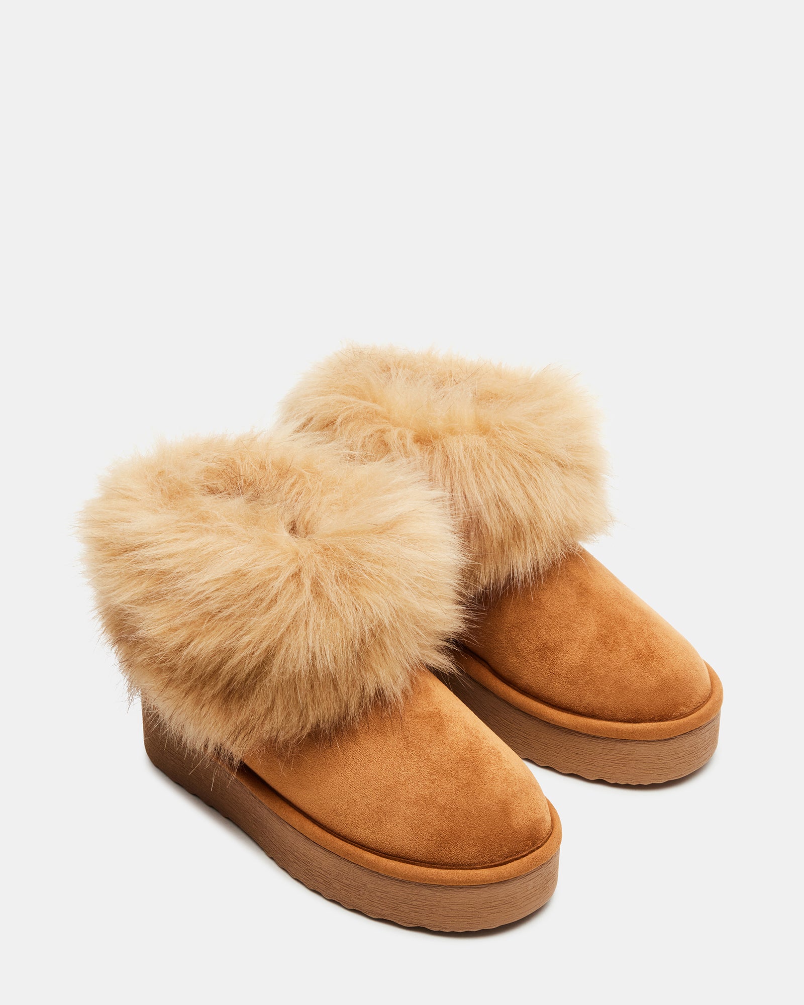 Side view of chestnut brown UGG boots on wooden floor