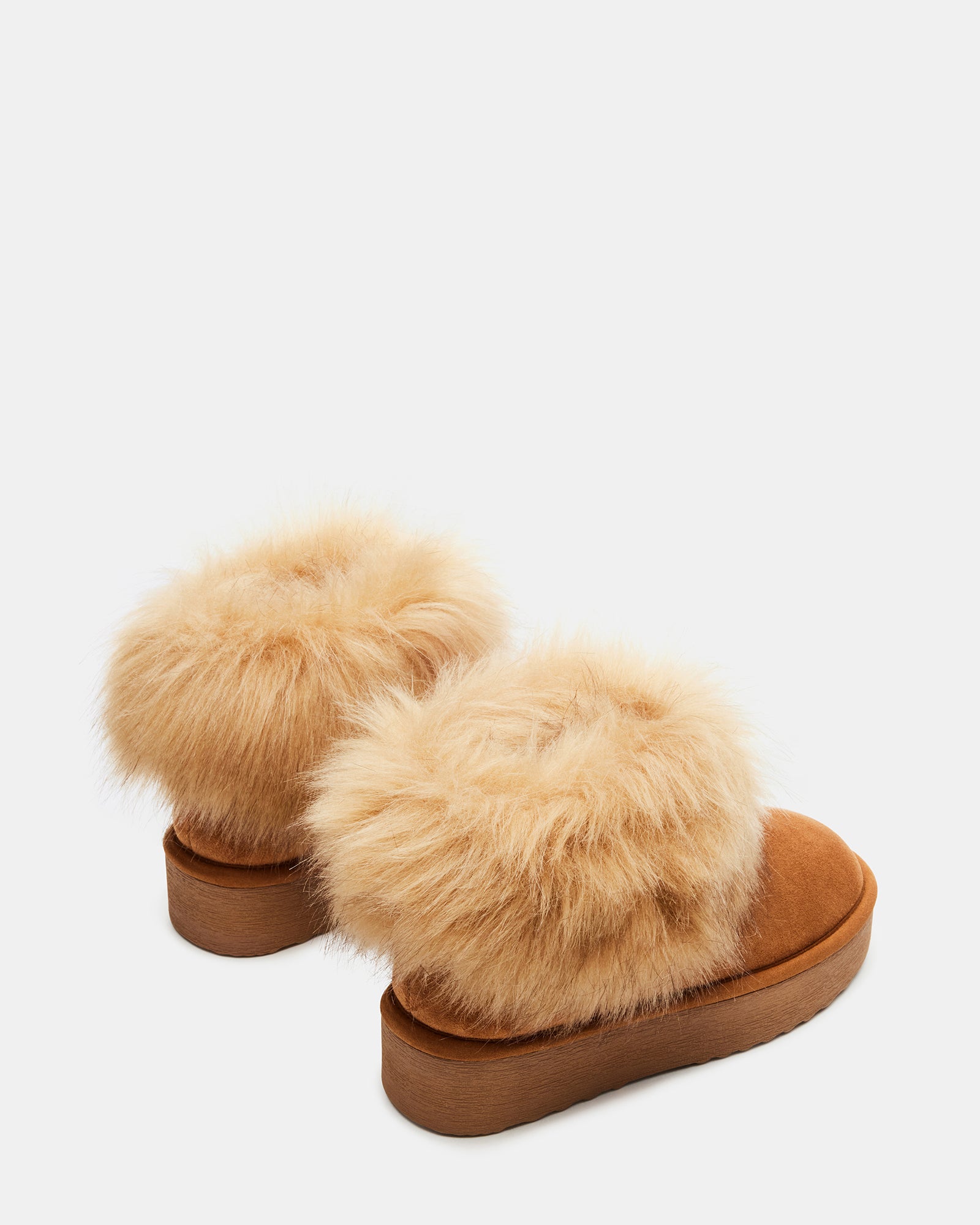 Side view of chestnut brown UGG boots on wooden floor