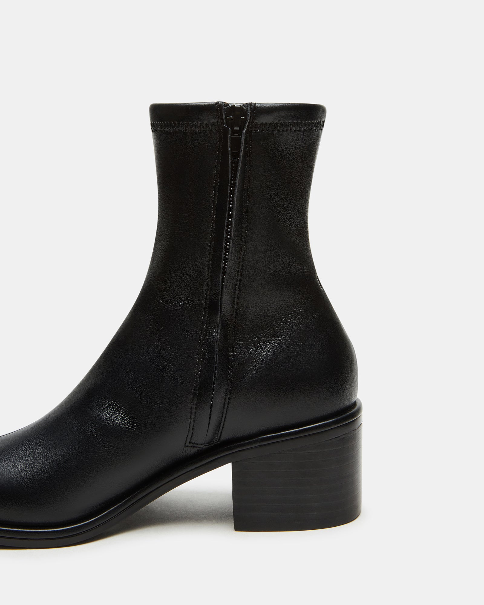 Close-up of the vegan leather upper and heel detail of CIARA Black boots