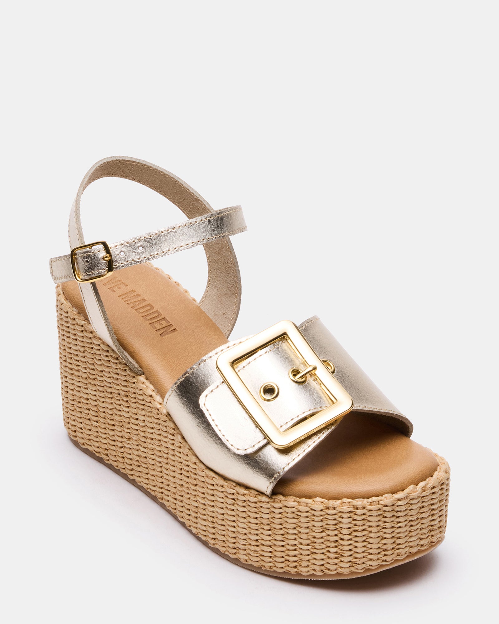 White wedge heel sandals with buckle detail, front angle