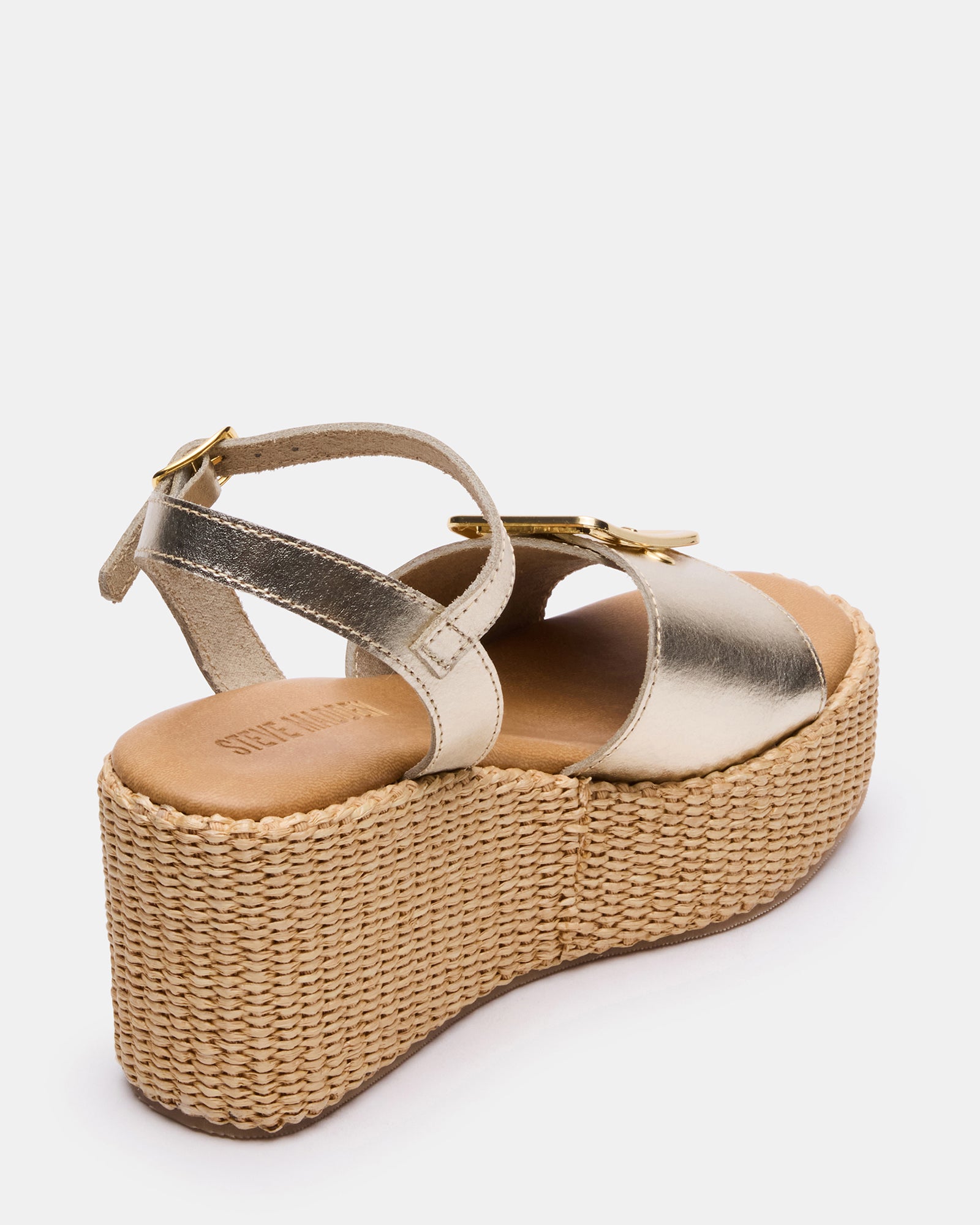 White wedge heel sandals with buckle detail, front angle