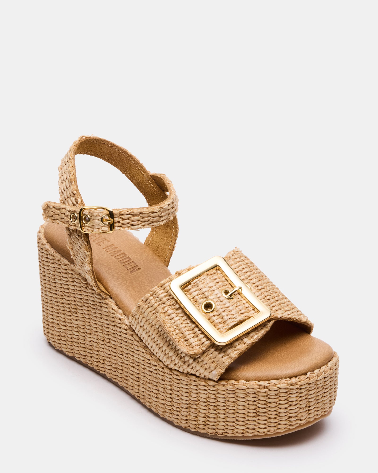 Overhead view of black platform sandals styled with coastal travel wear
