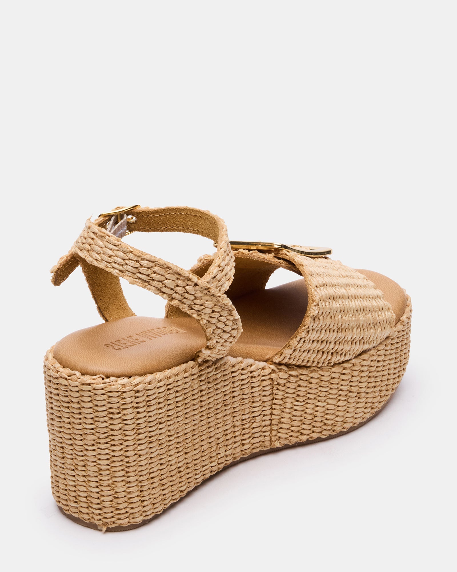 Overhead view of black platform sandals styled with coastal travel wear