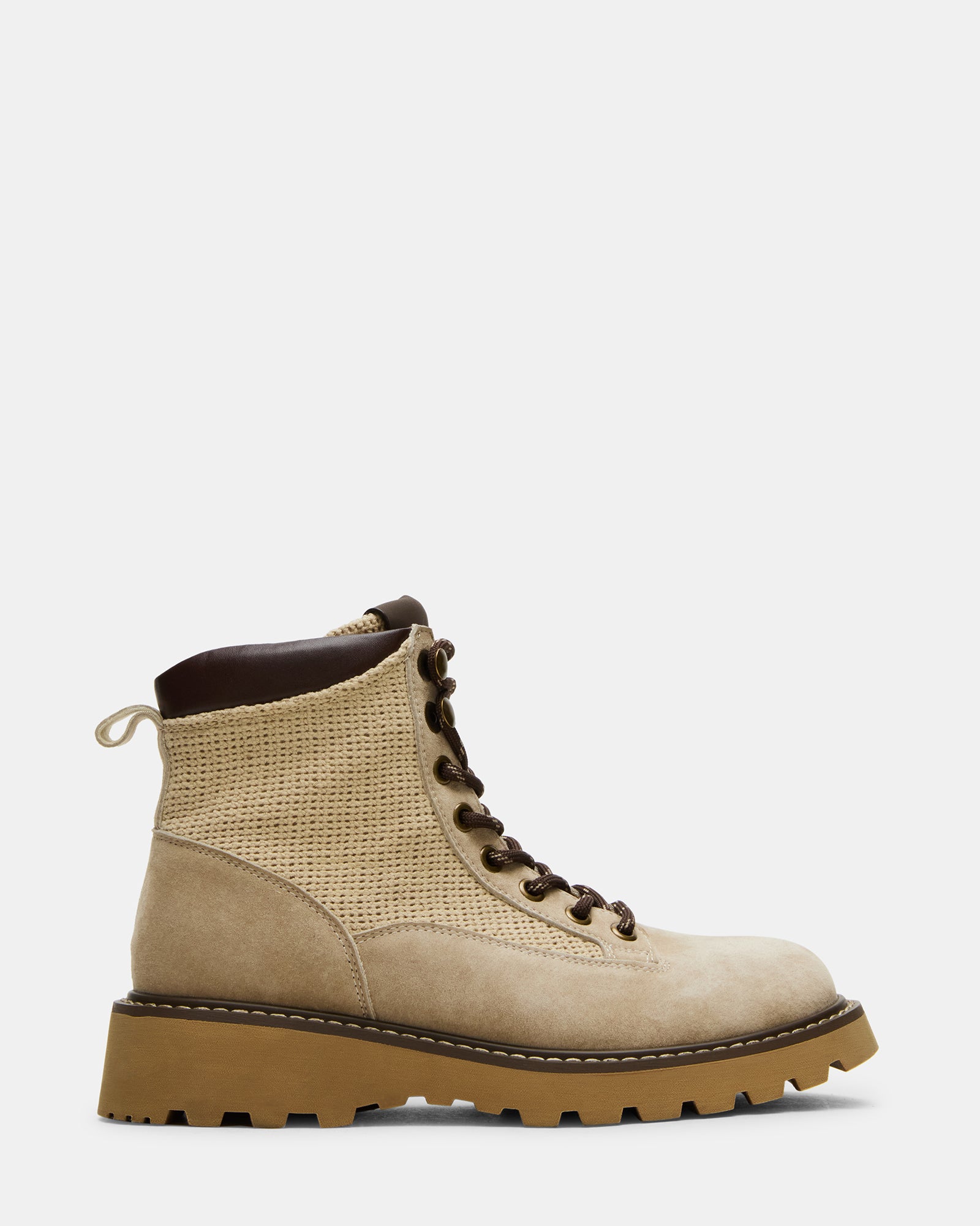 Side view of brown suede cowboy boots styled with denim for outdoor wear
