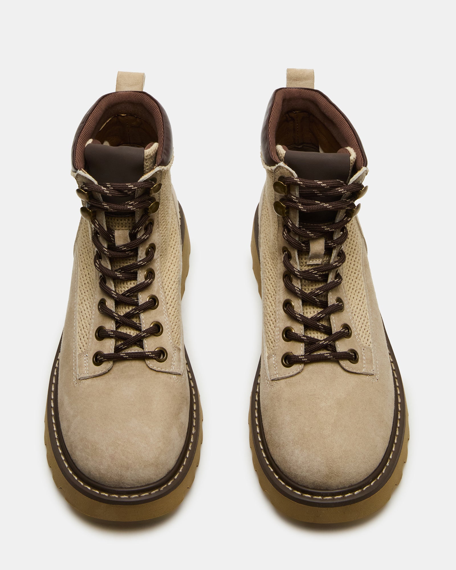Side view of brown suede cowboy boots styled with denim for outdoor wear