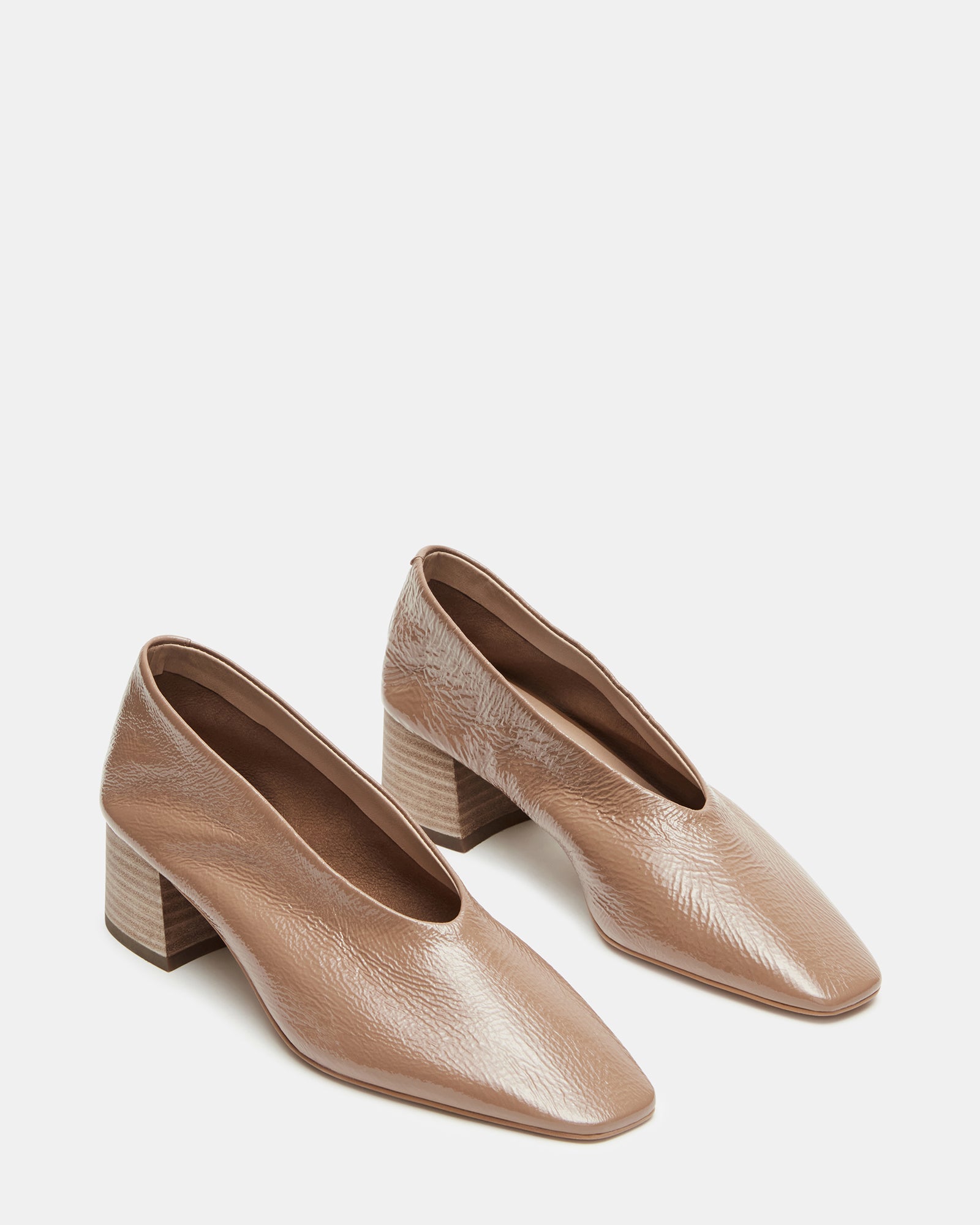 Lifestyle shot featuring flat shoes worn with tailored pants outdoors
