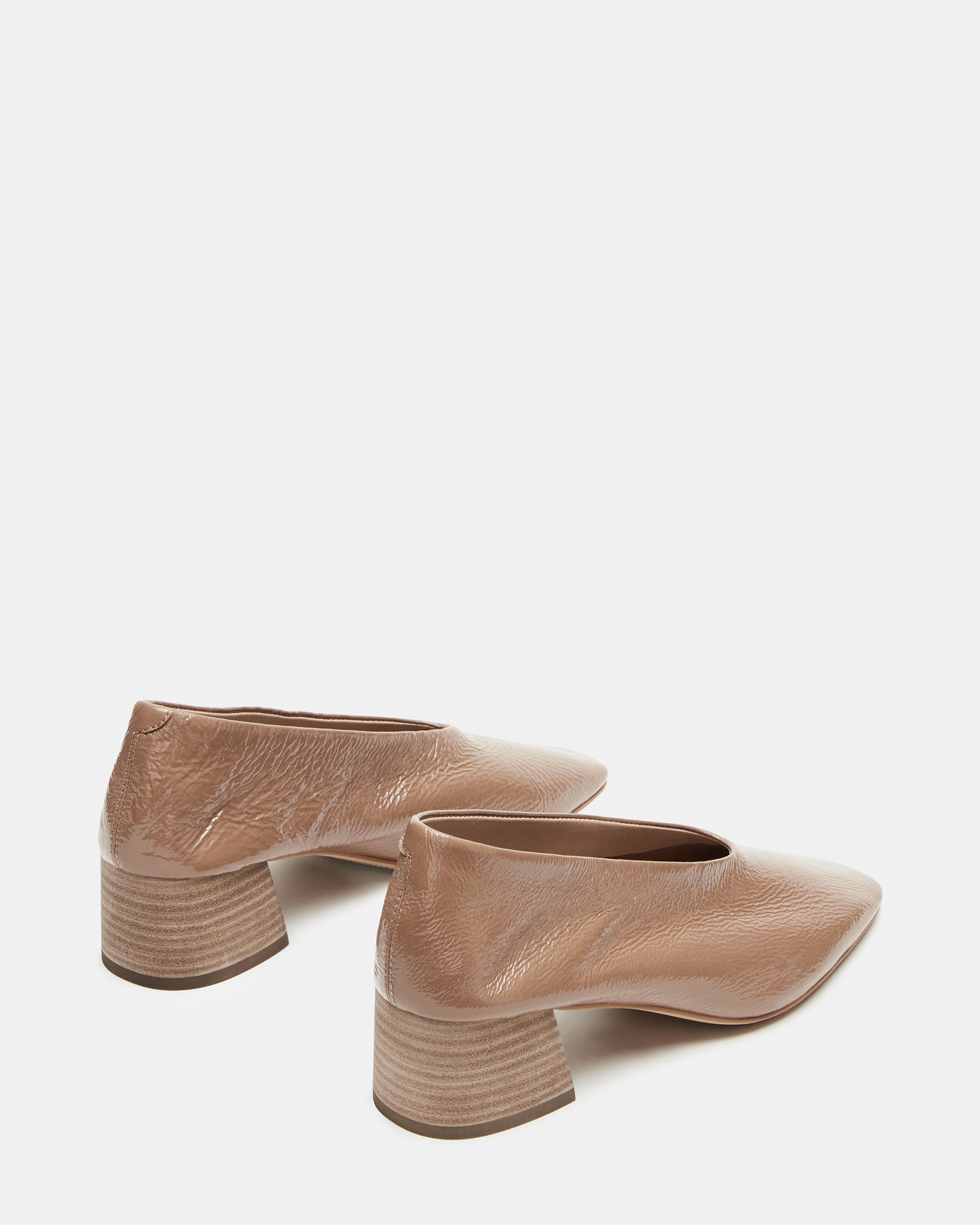 Lifestyle shot featuring flat shoes worn with tailored pants outdoors