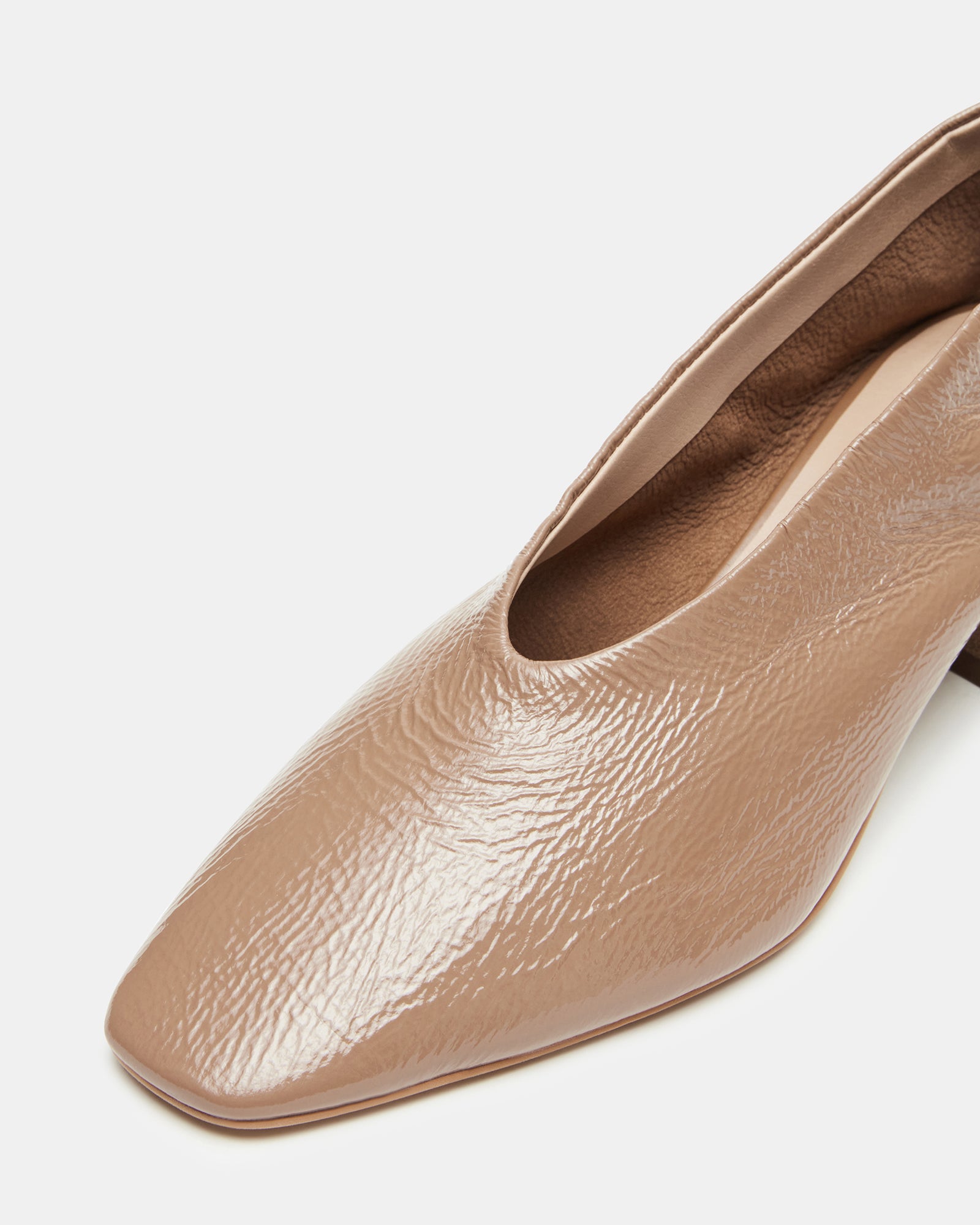 Close-up of leather shoes detailing texture and patent shine