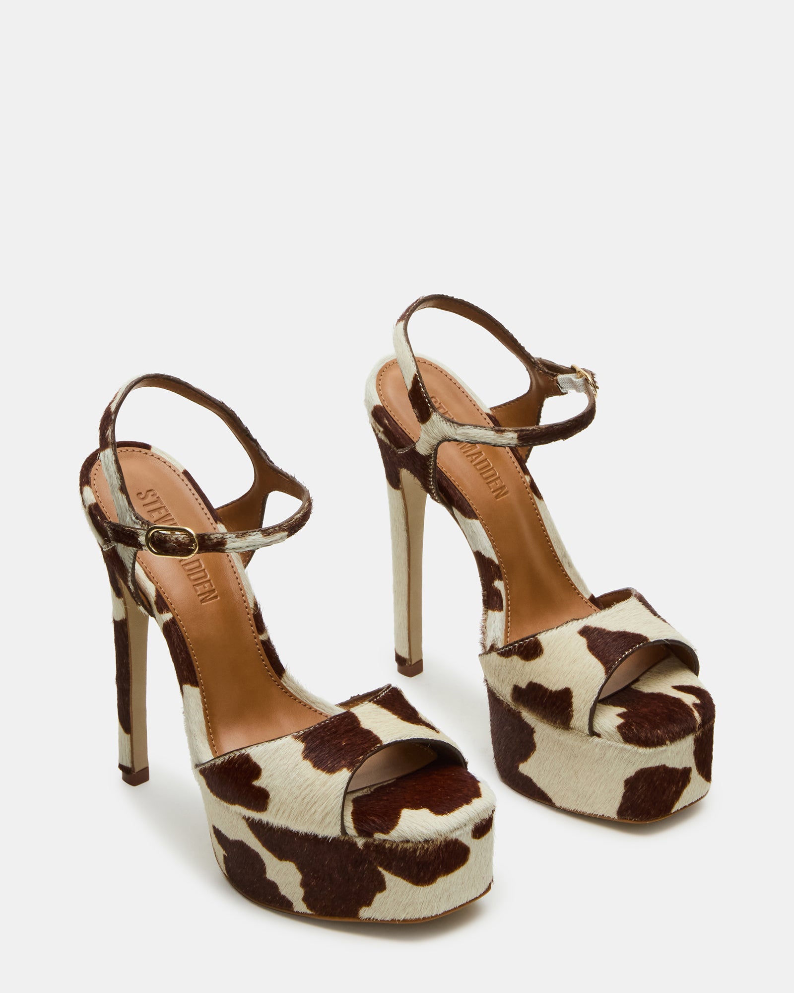 Close-up of square-toe leather heels with cow print pattern