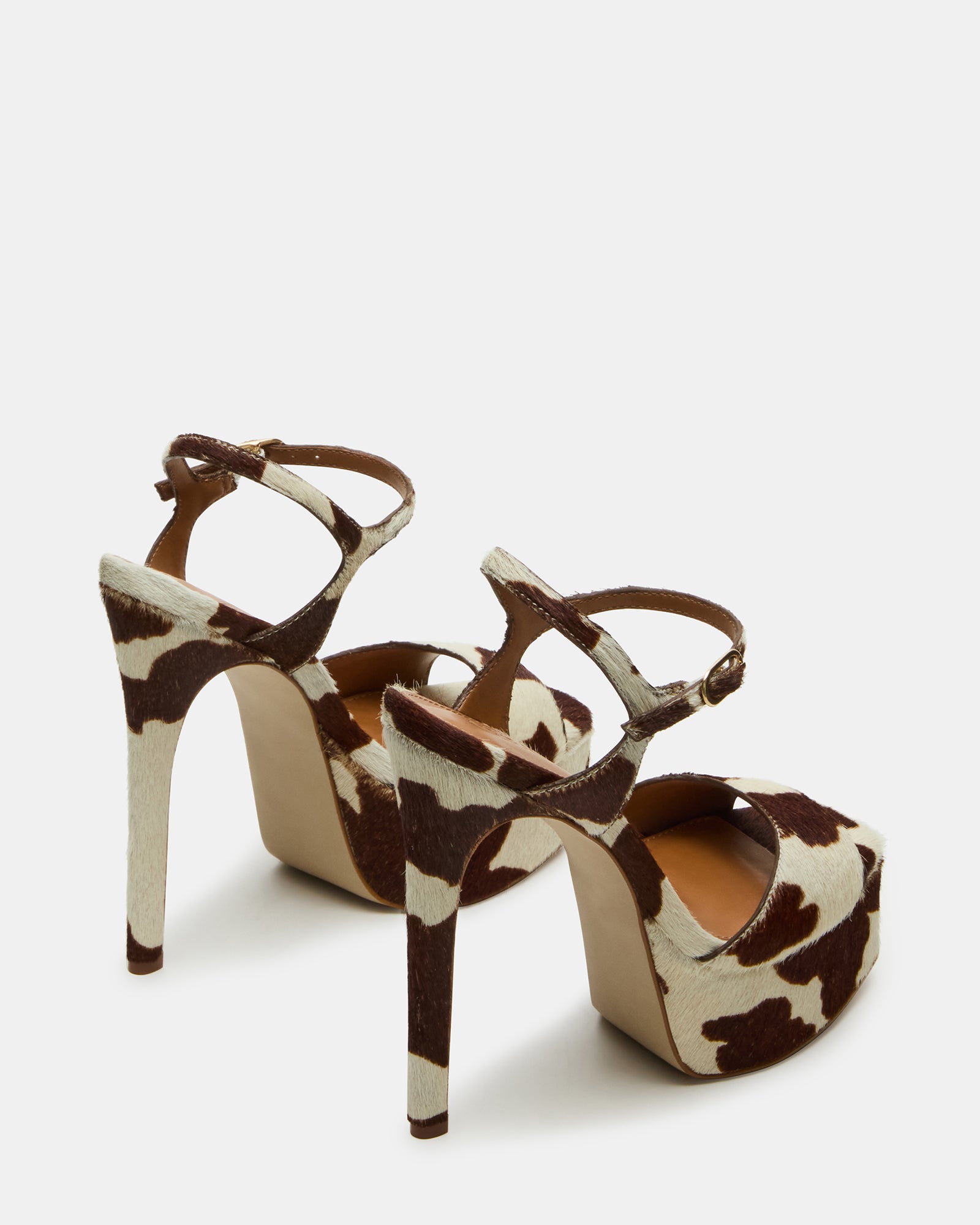 Close-up of square-toe leather heels with cow print pattern