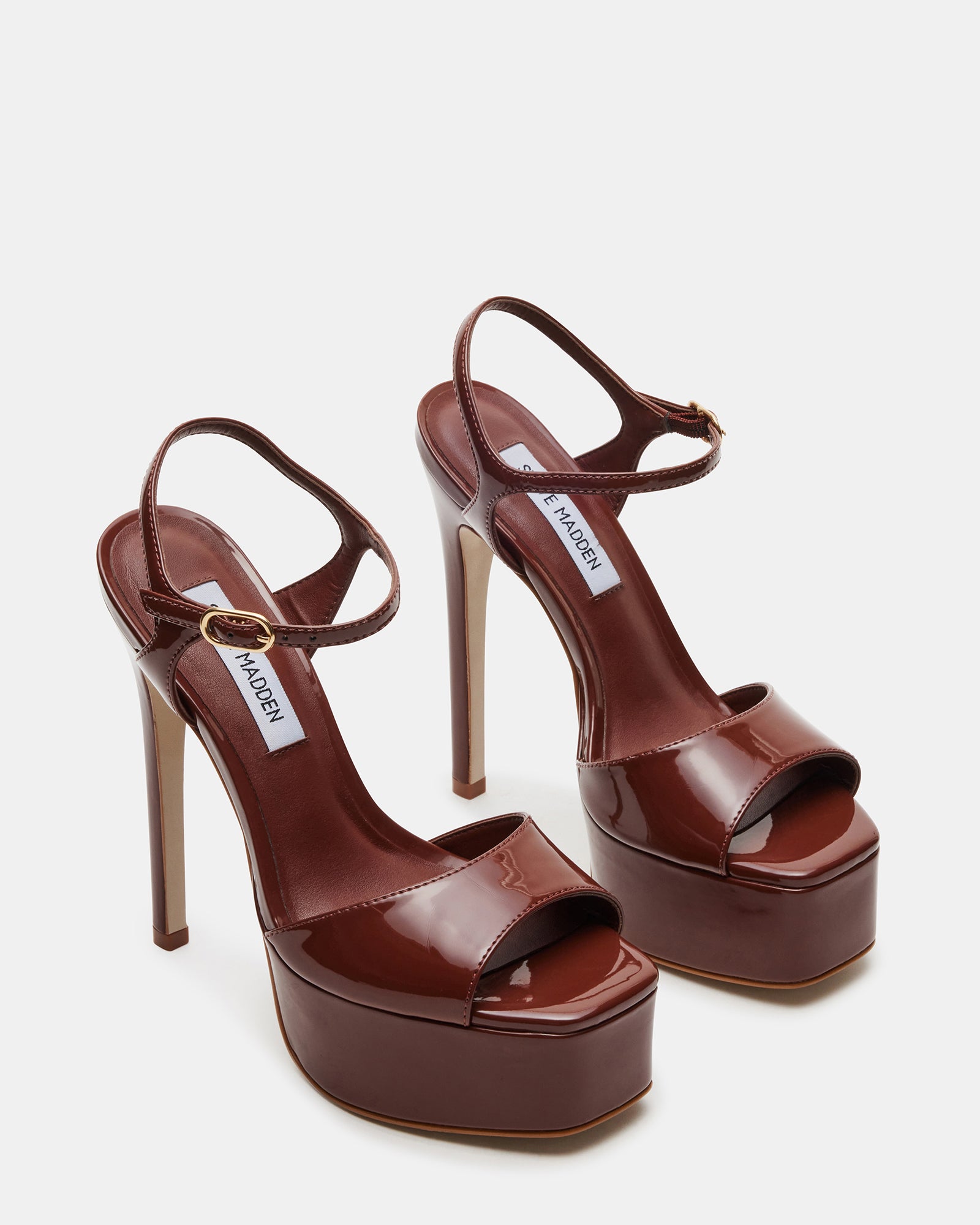 Close-up of the synthetic upper material of the brown patent heels.