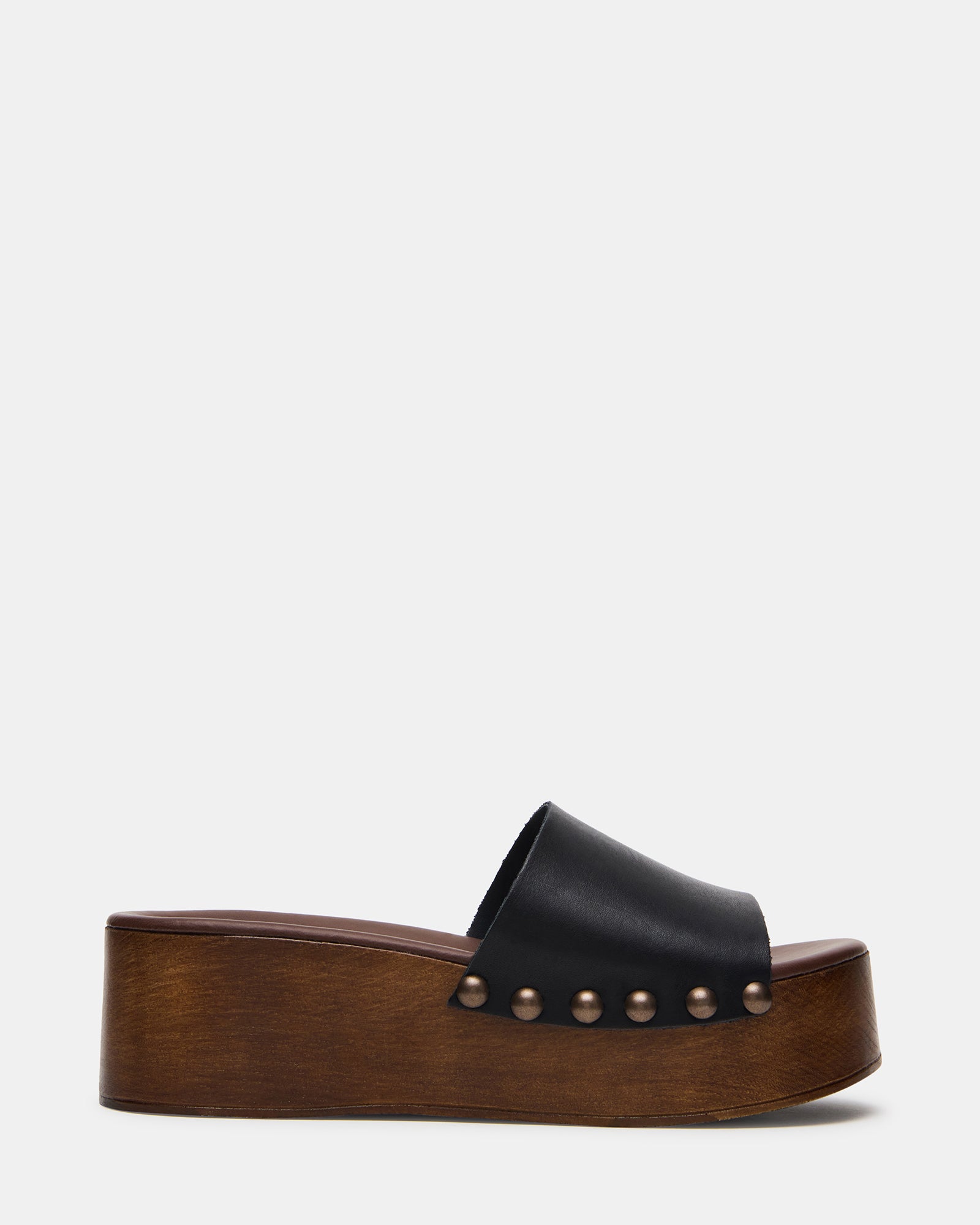 Top-down shot of black platform sandals showing leather detailing and flatform base