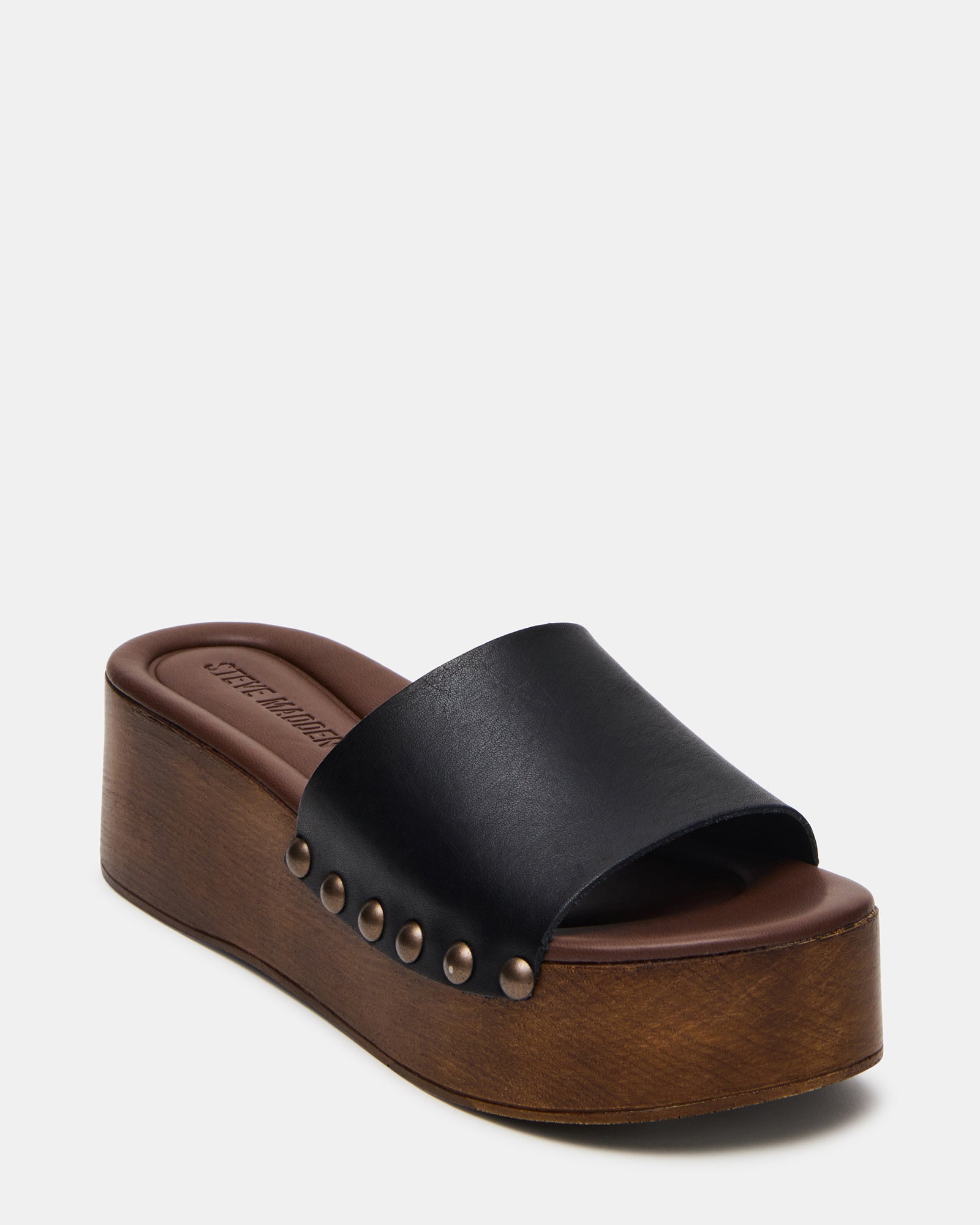 Lifestyle image featuring sandals for women with platform design, styled on city street