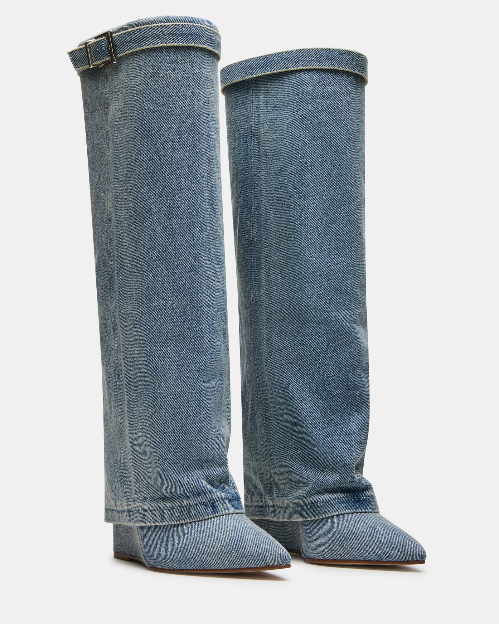 Model wearing knee high black boots with folded cuff