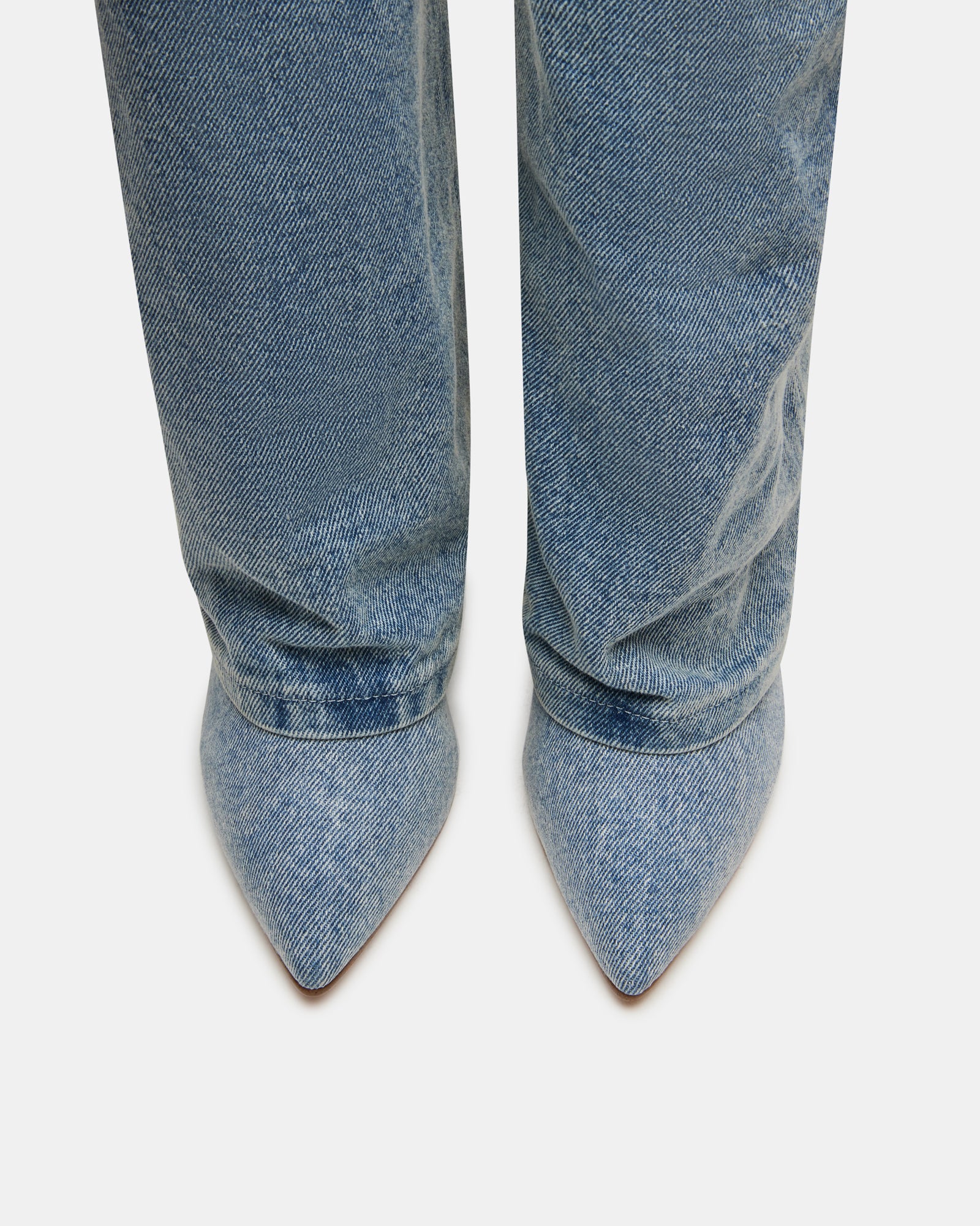 Close-up of CORENNE denim boot buckle and pointed toe