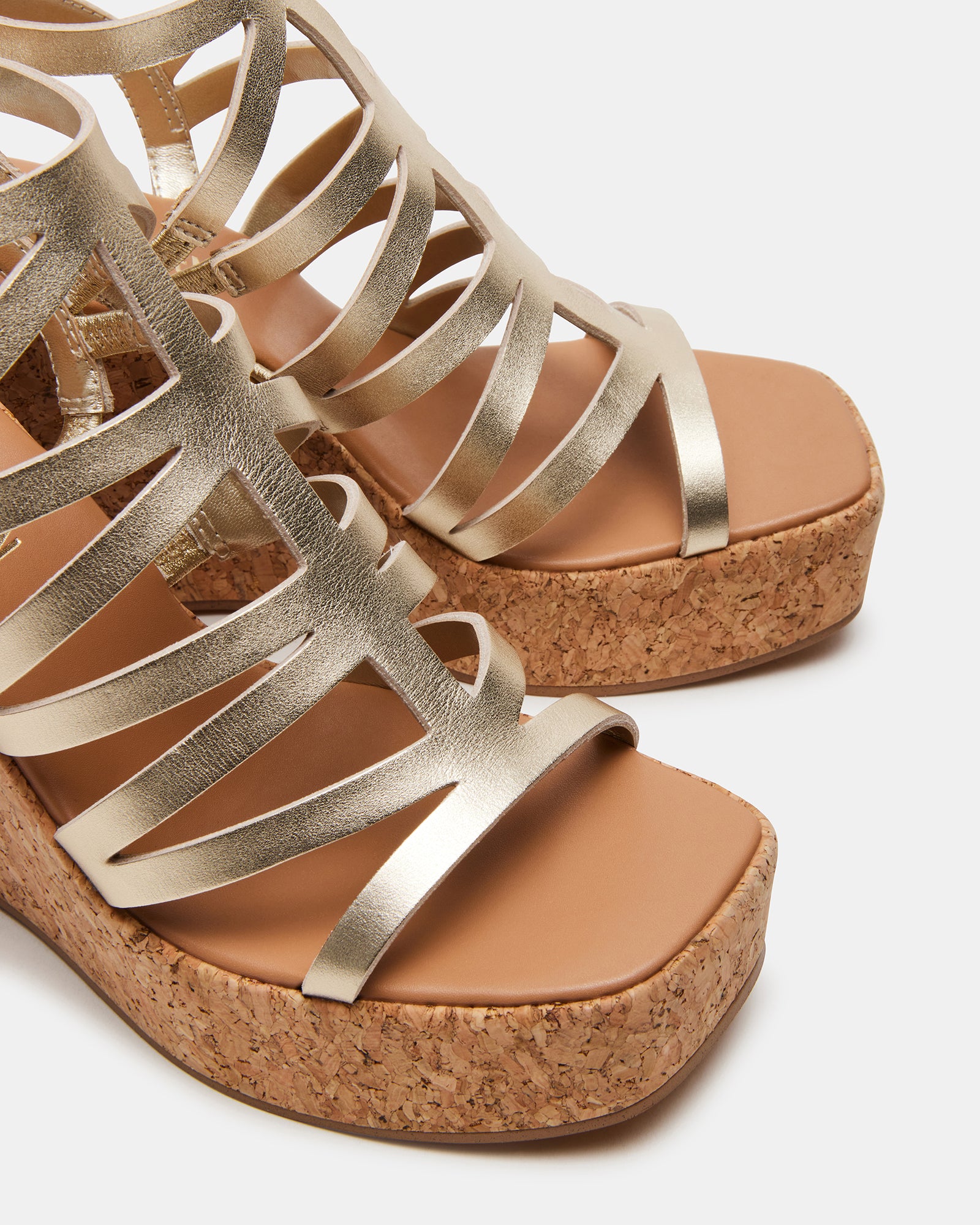 Black wedge sandals paired with casual summer attire.
