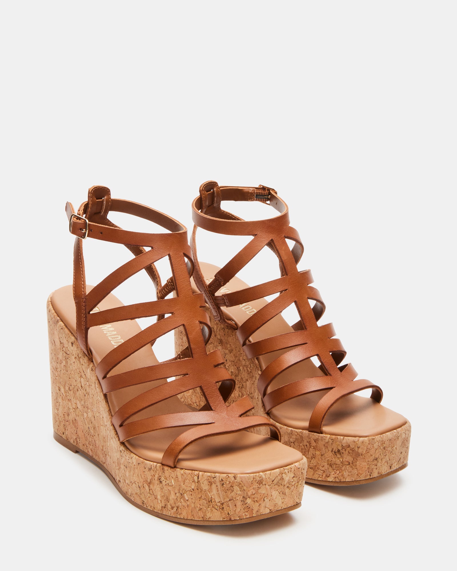 Cozette tan leather platform sandals worn at a summer event.