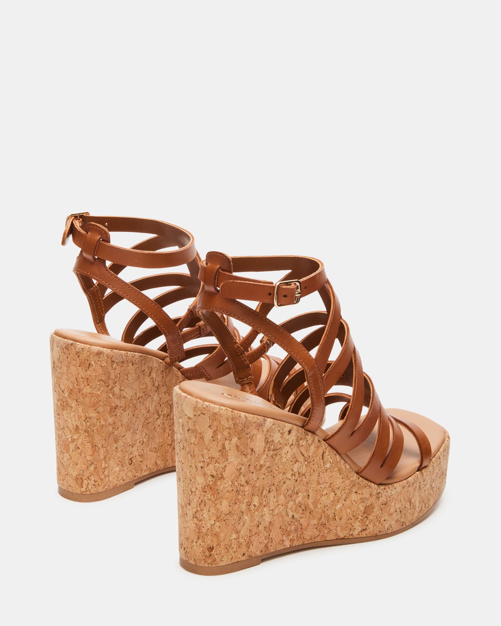 Cozette tan leather platform sandals worn at a summer event.