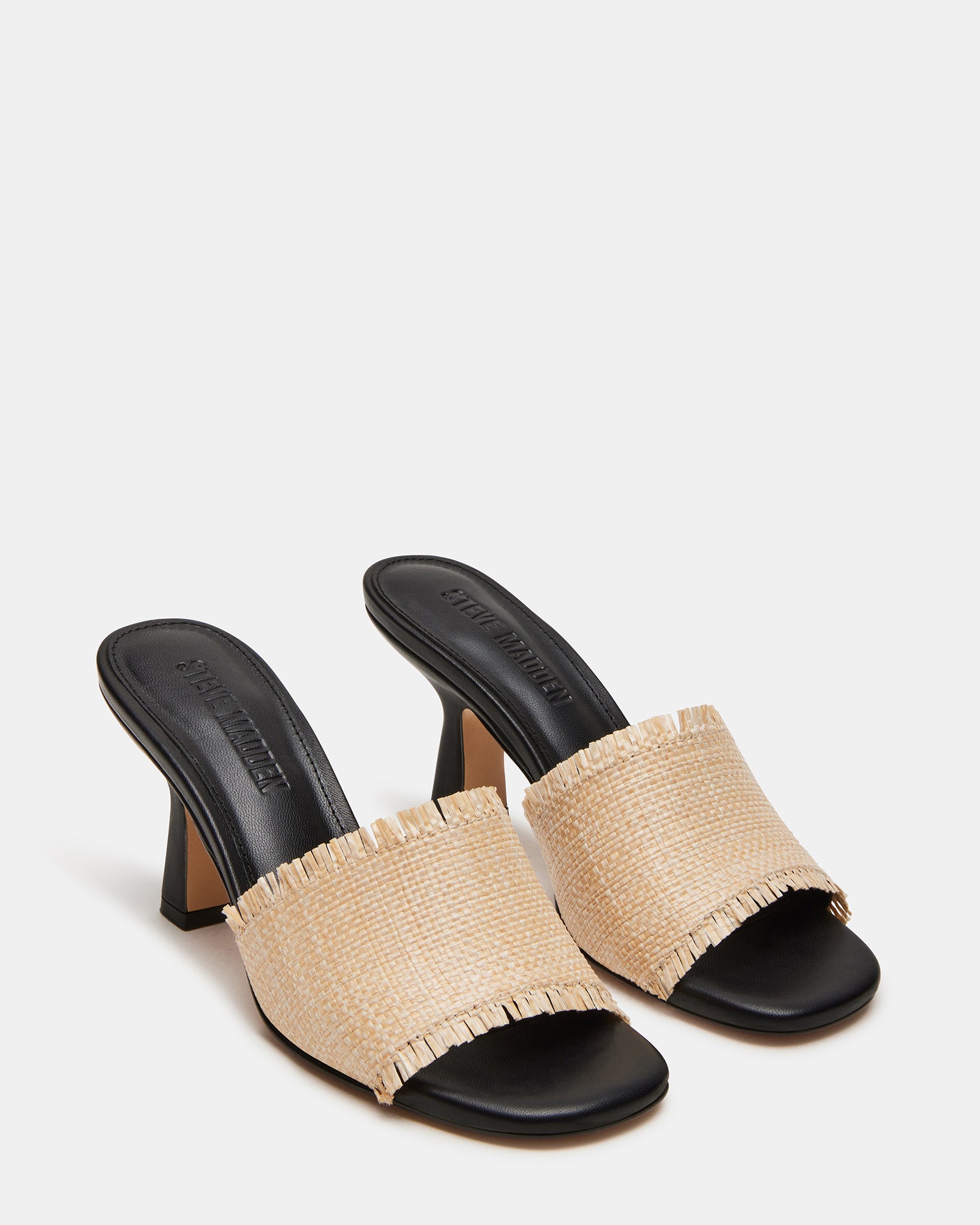 Side profile of womens mule heels styled with a summer outfit.