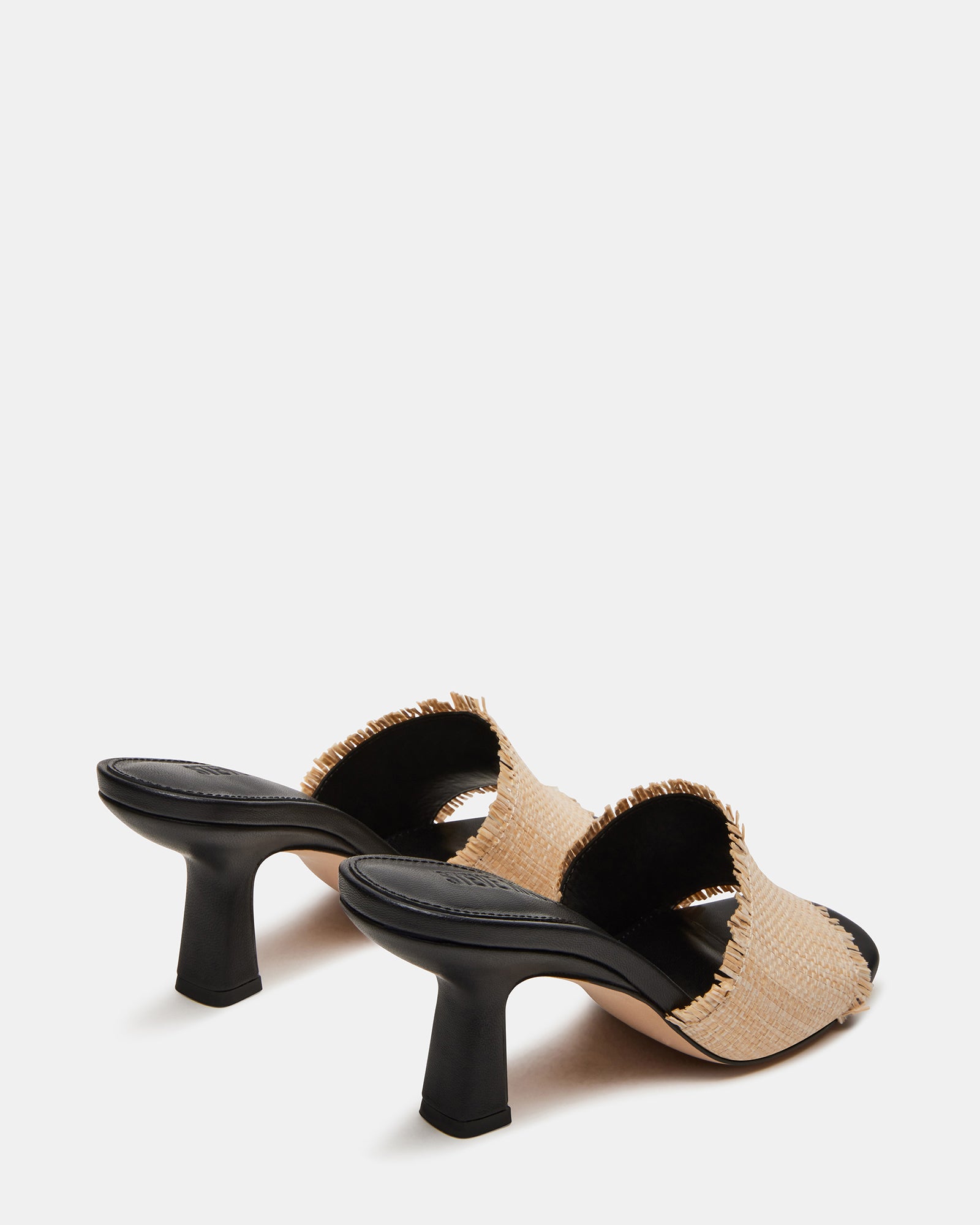 Side profile of womens mule heels styled with a summer outfit.
