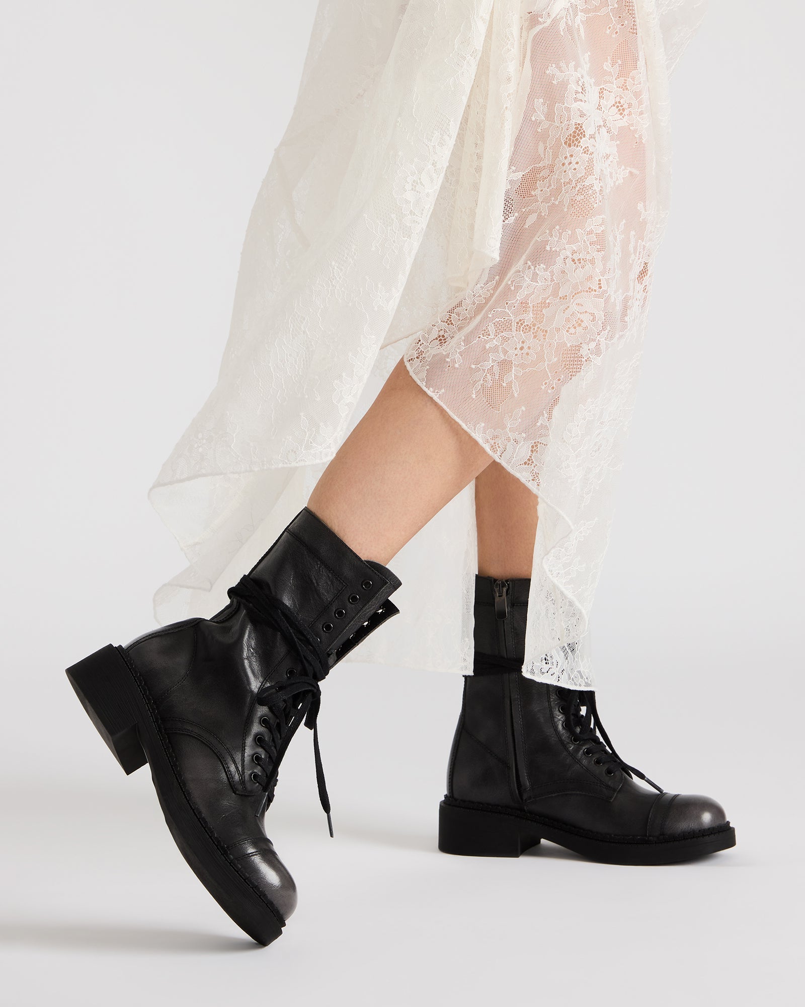 Side angle of womens combat boots, highlighting the lace-up design and heel height.