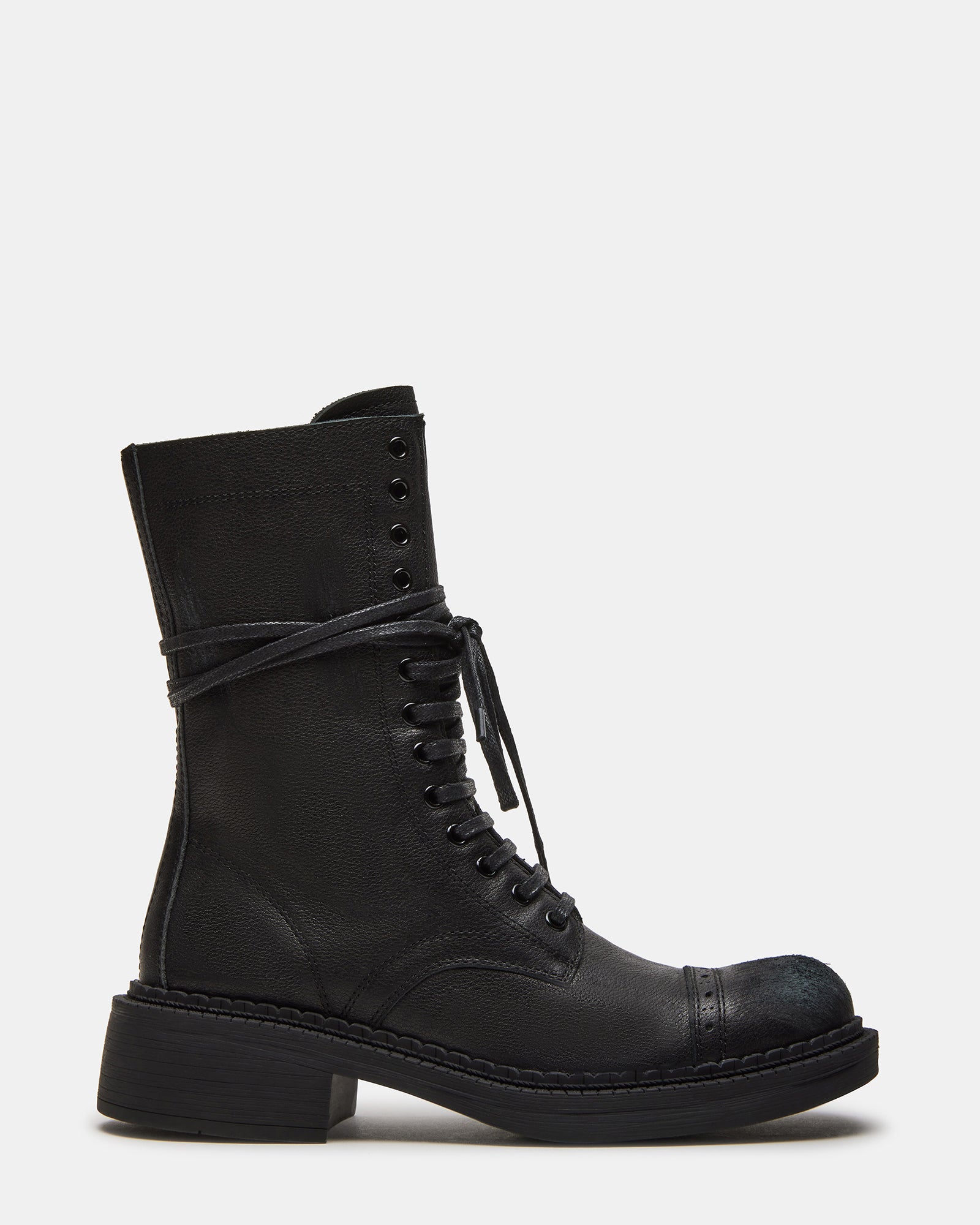 Side view of black combat boots showcasing the moto-inspired stitching