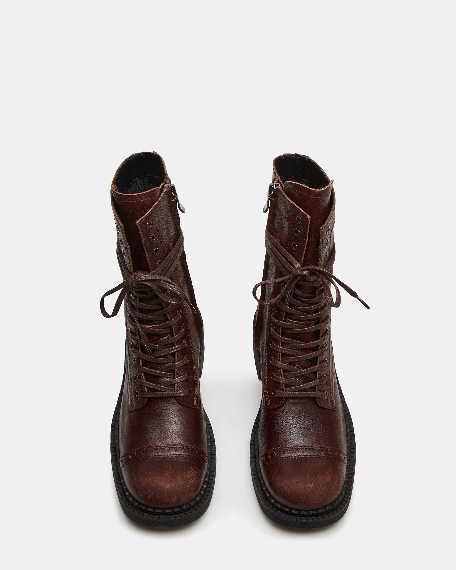 Front angle of lace-up womens combat boots on a wooden floor