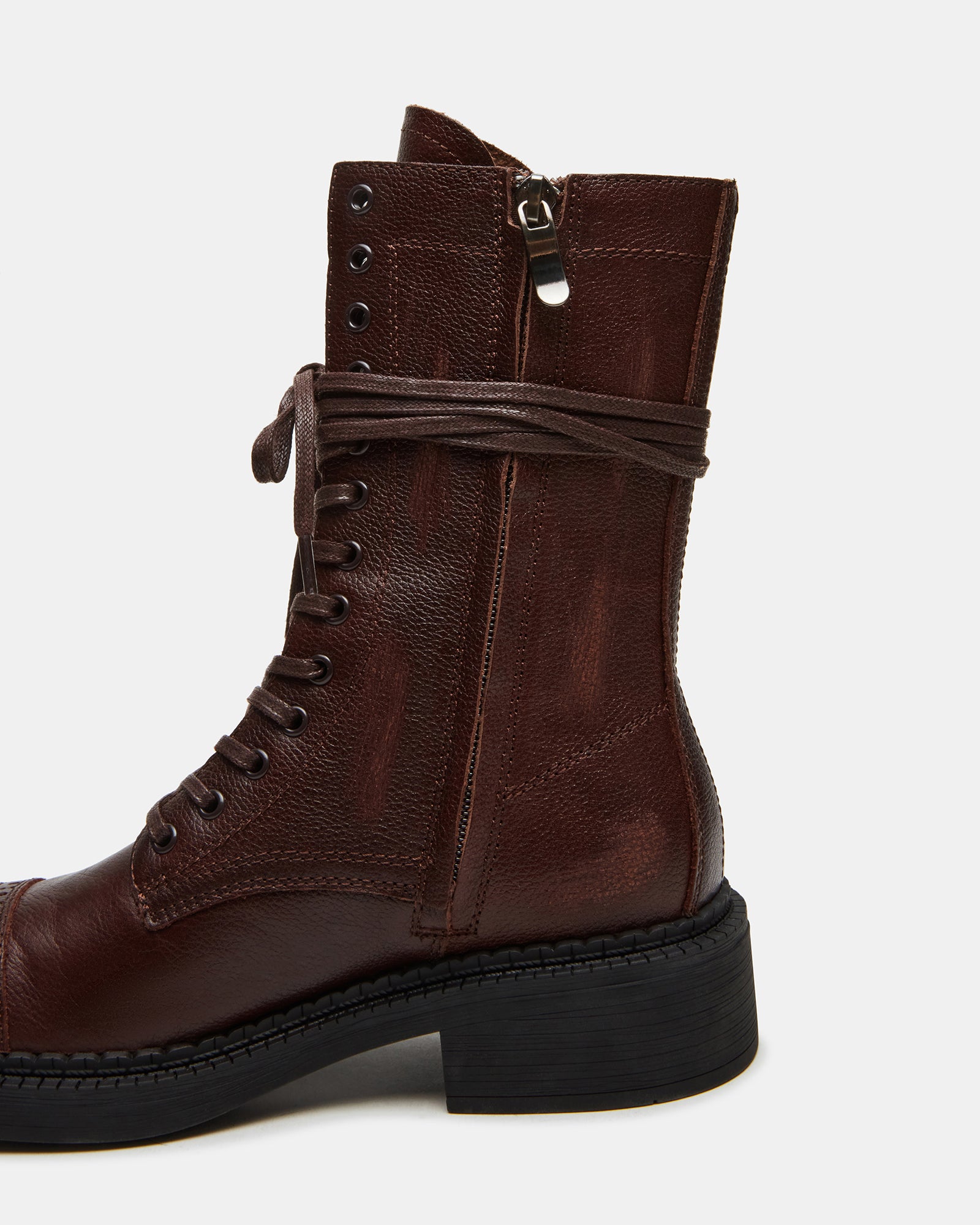 Side view of brown leather combat boots showcasing moto-style stitching