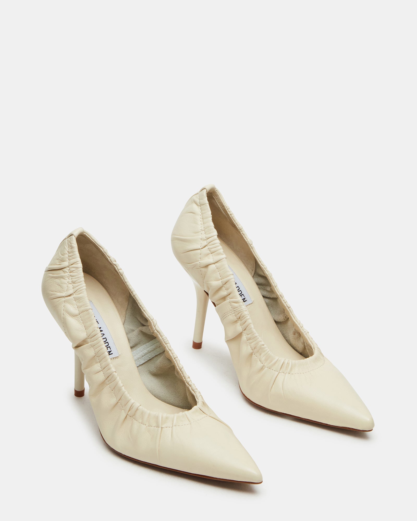 Close-up of pointed toe heeled shoes against neutral backdrop
