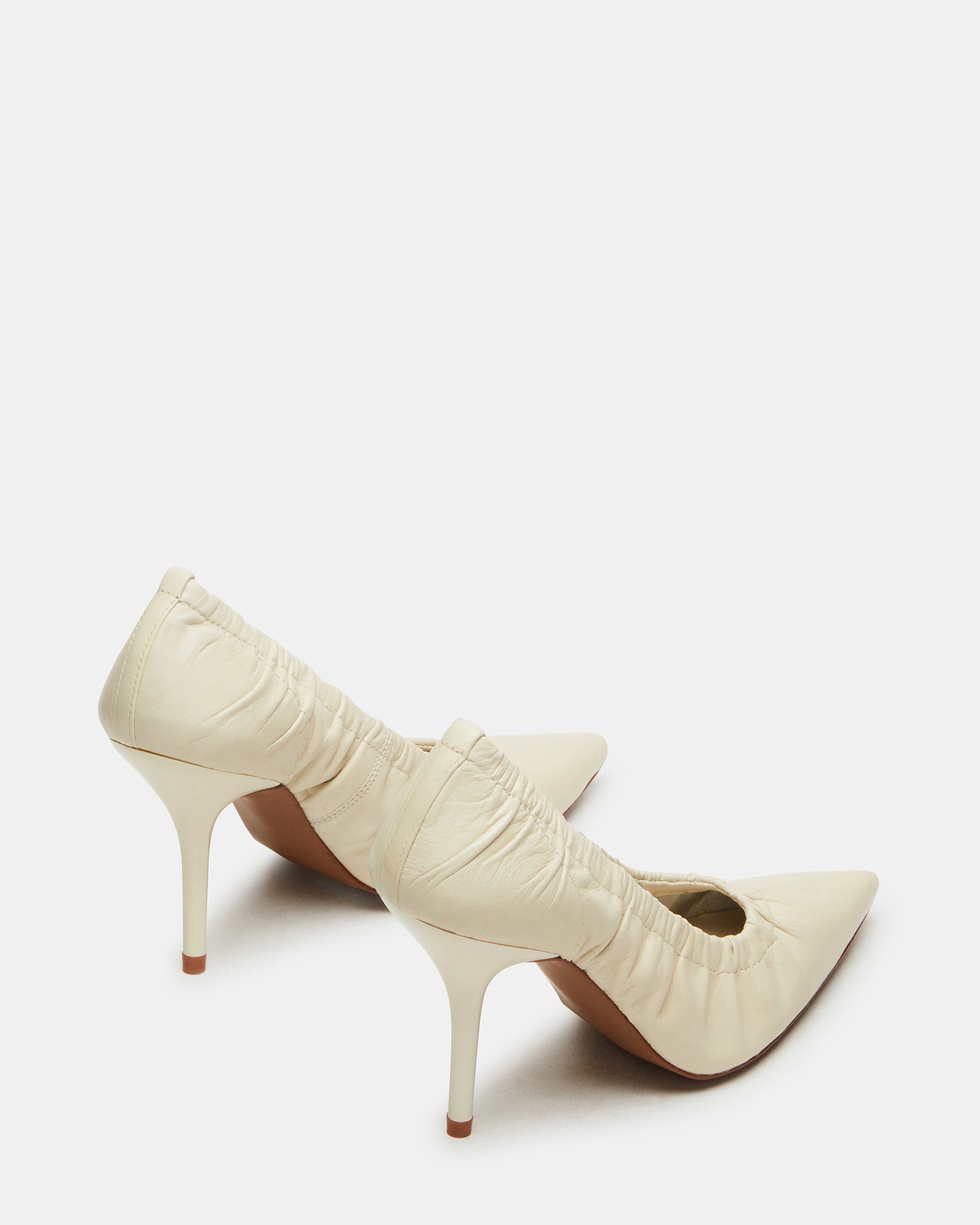 Close-up of pointed toe heeled shoes against neutral backdrop