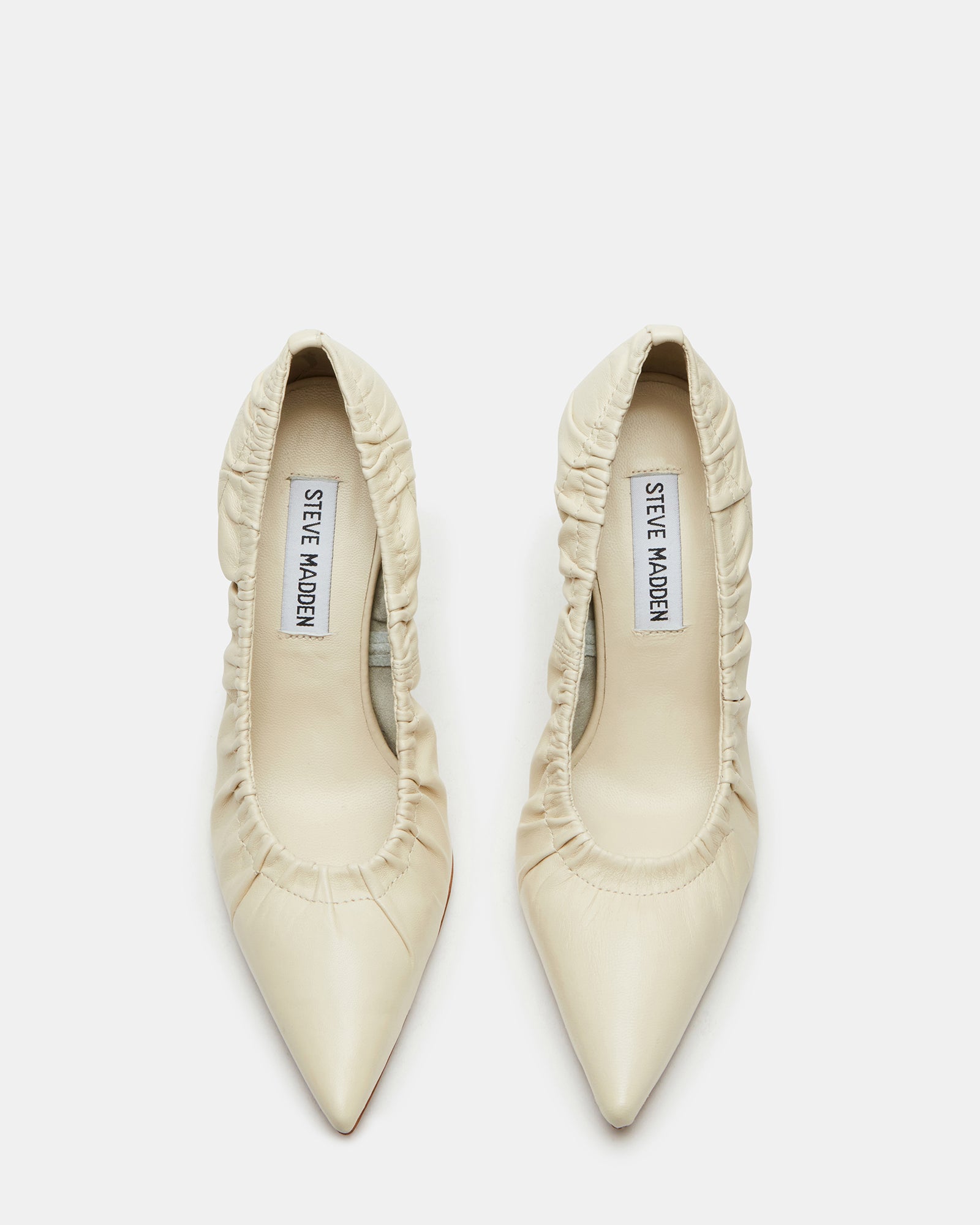 Crinkle bone leather black patent pumps angled on marble steps