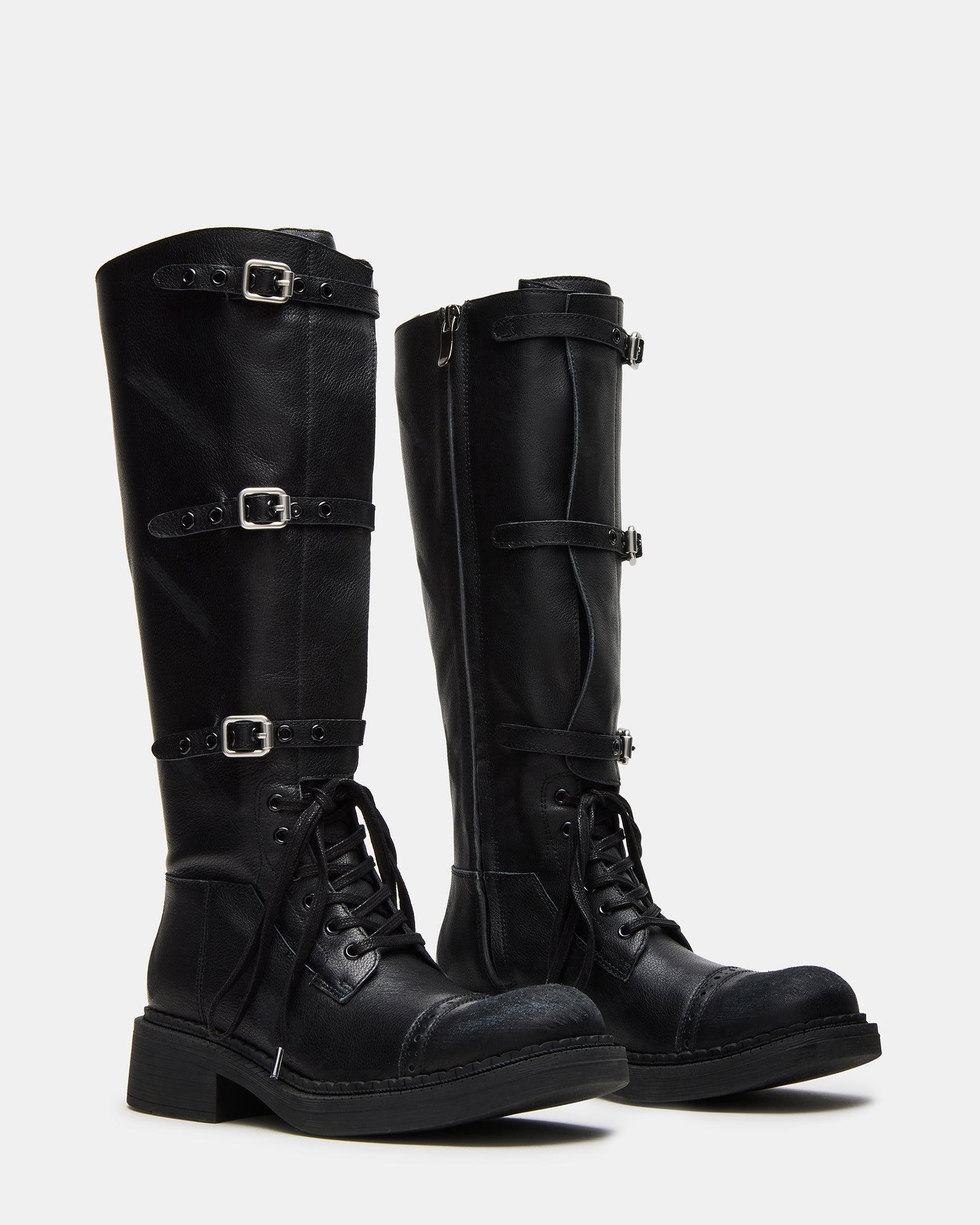 Woman wearing black square toe boots with cuffed jeans
