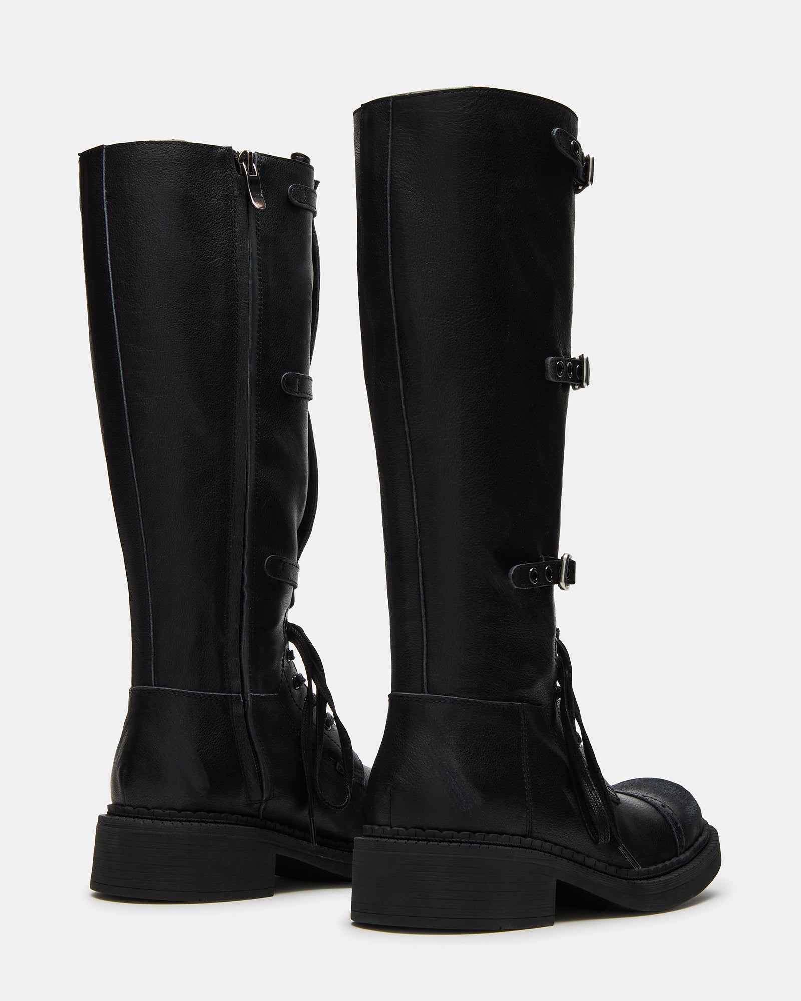 Woman wearing black square toe boots with cuffed jeans