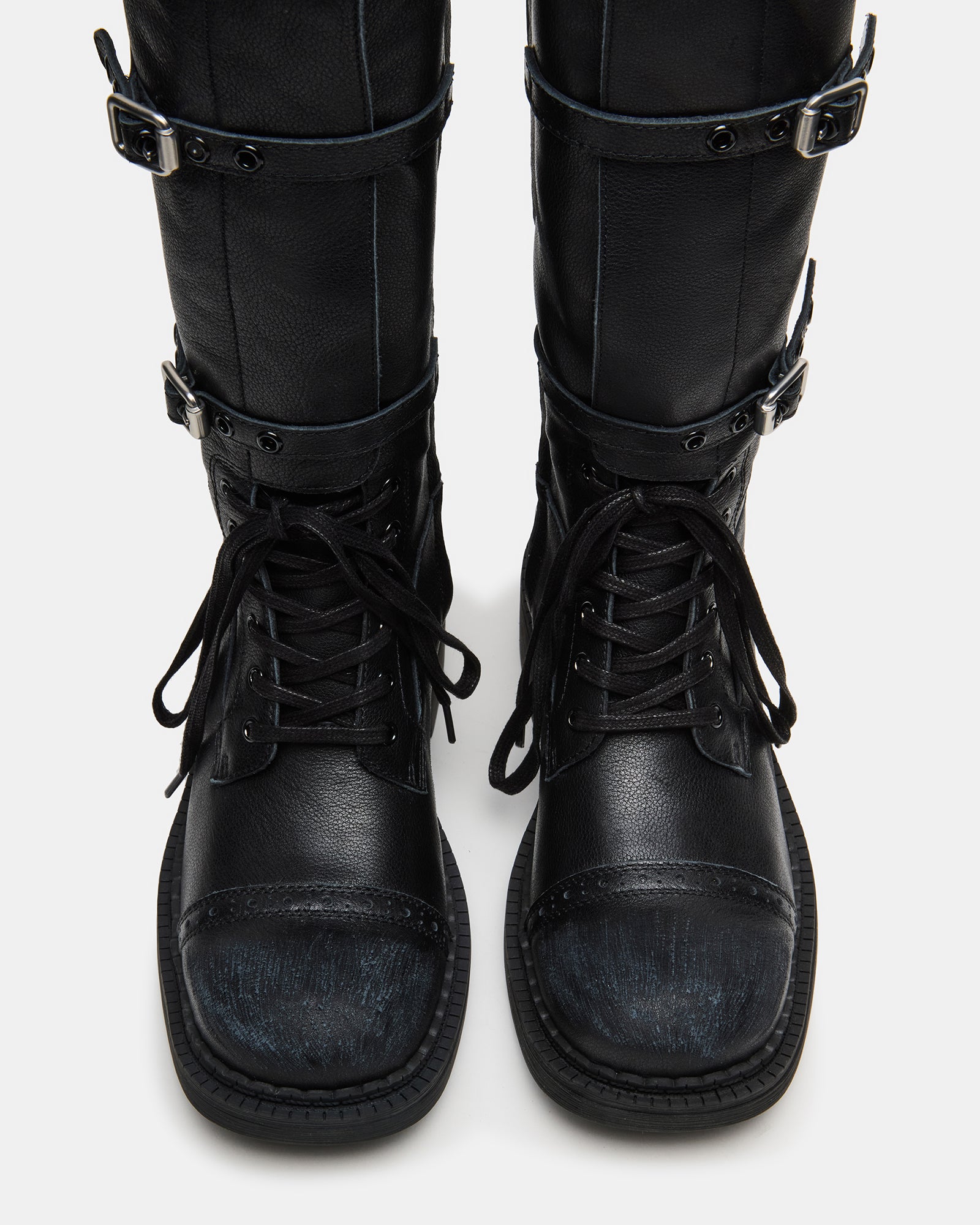Close-up of lace-up moto boot detailing with brass eyelets