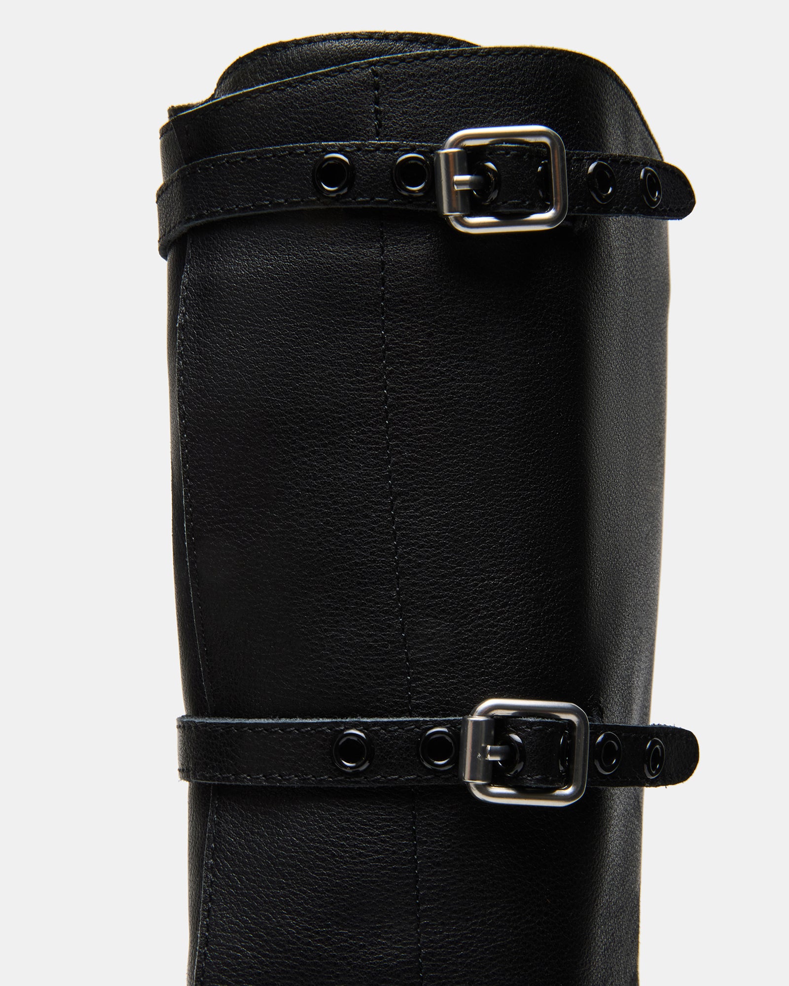 Side view of mens square toe boots on textured concrete