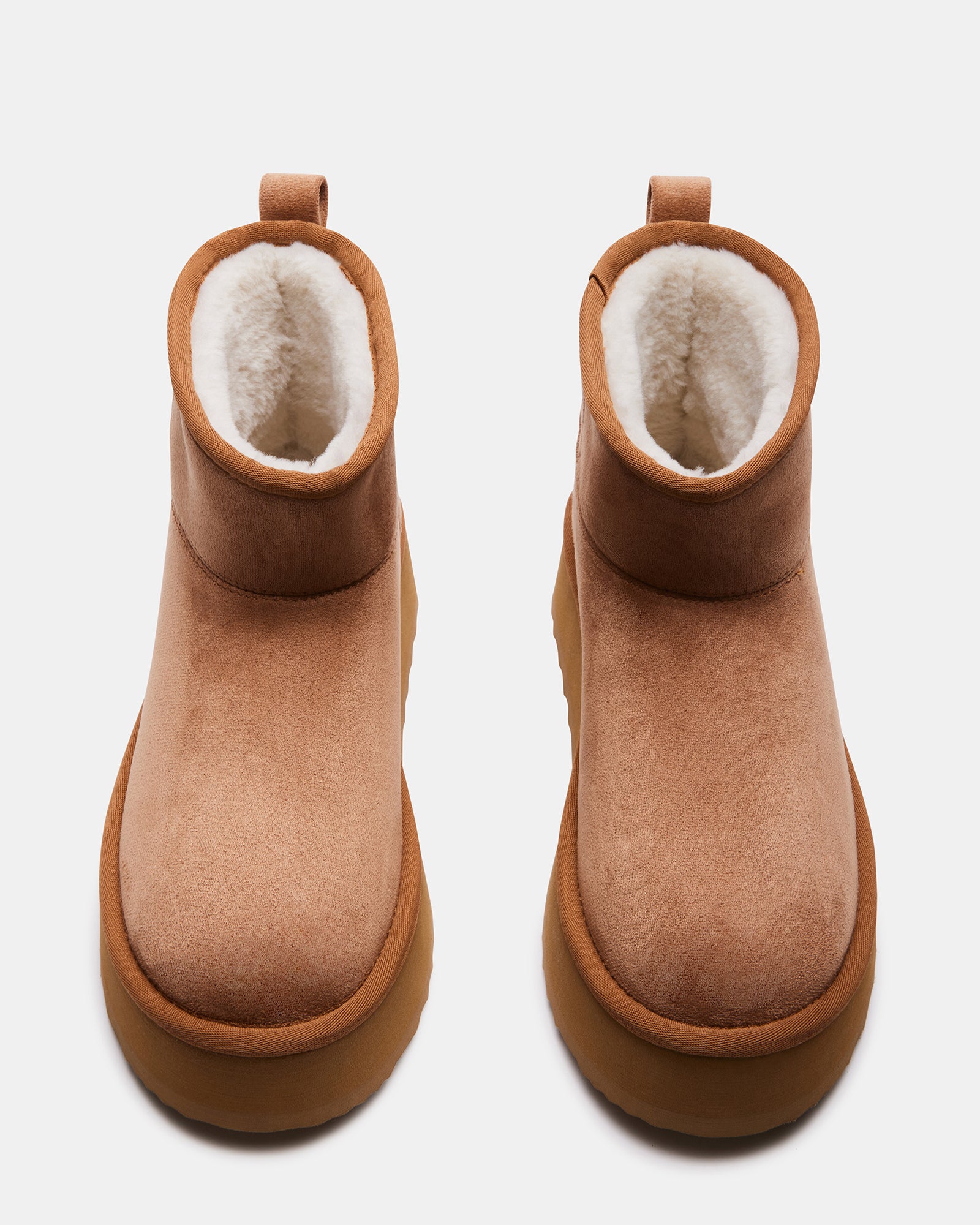 Lifestyle image of womens winter snow boots worn on a snowy sidewalk in Chicago.