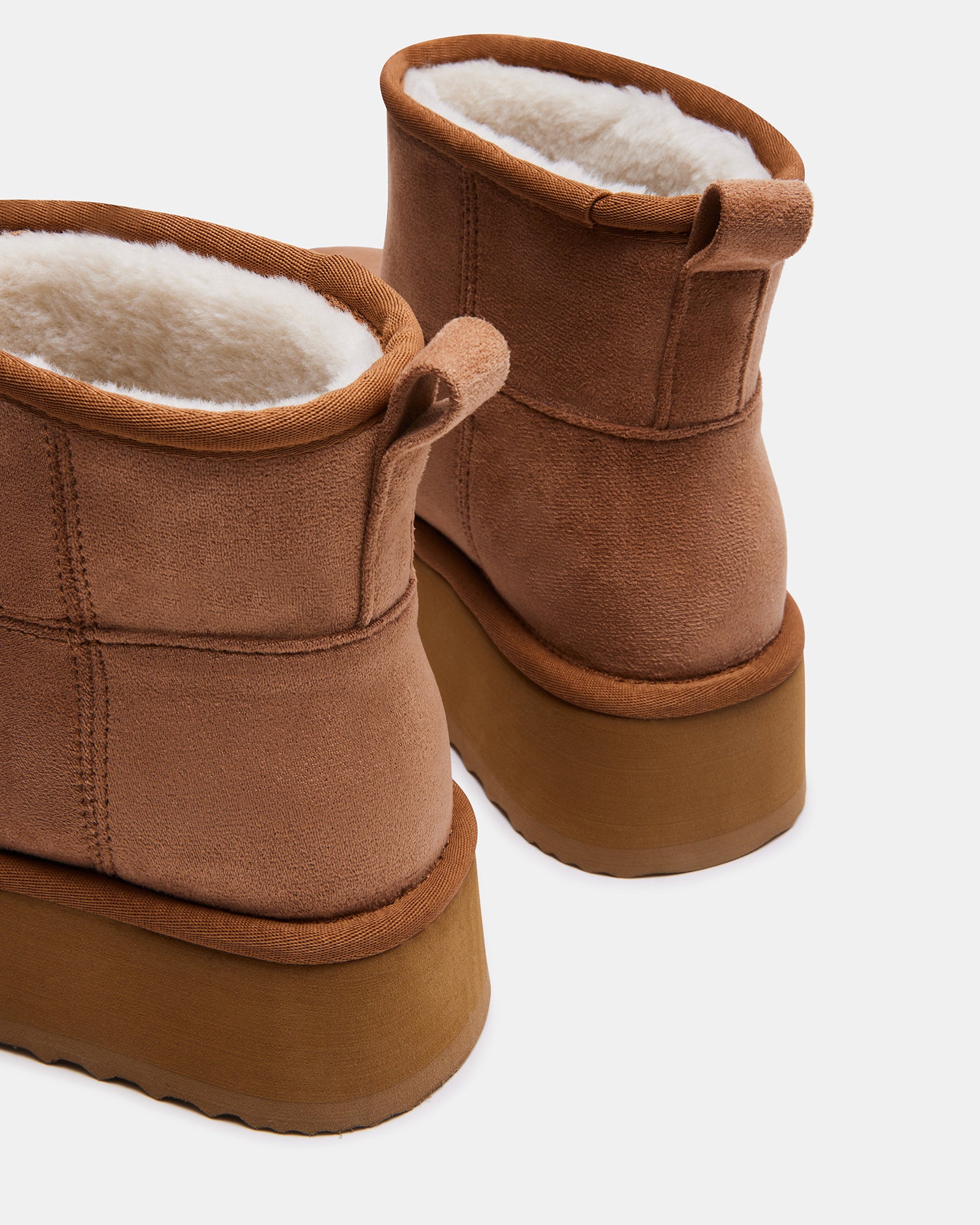 Side view of the faux shearling bootie showing platform height and microsuede texture.